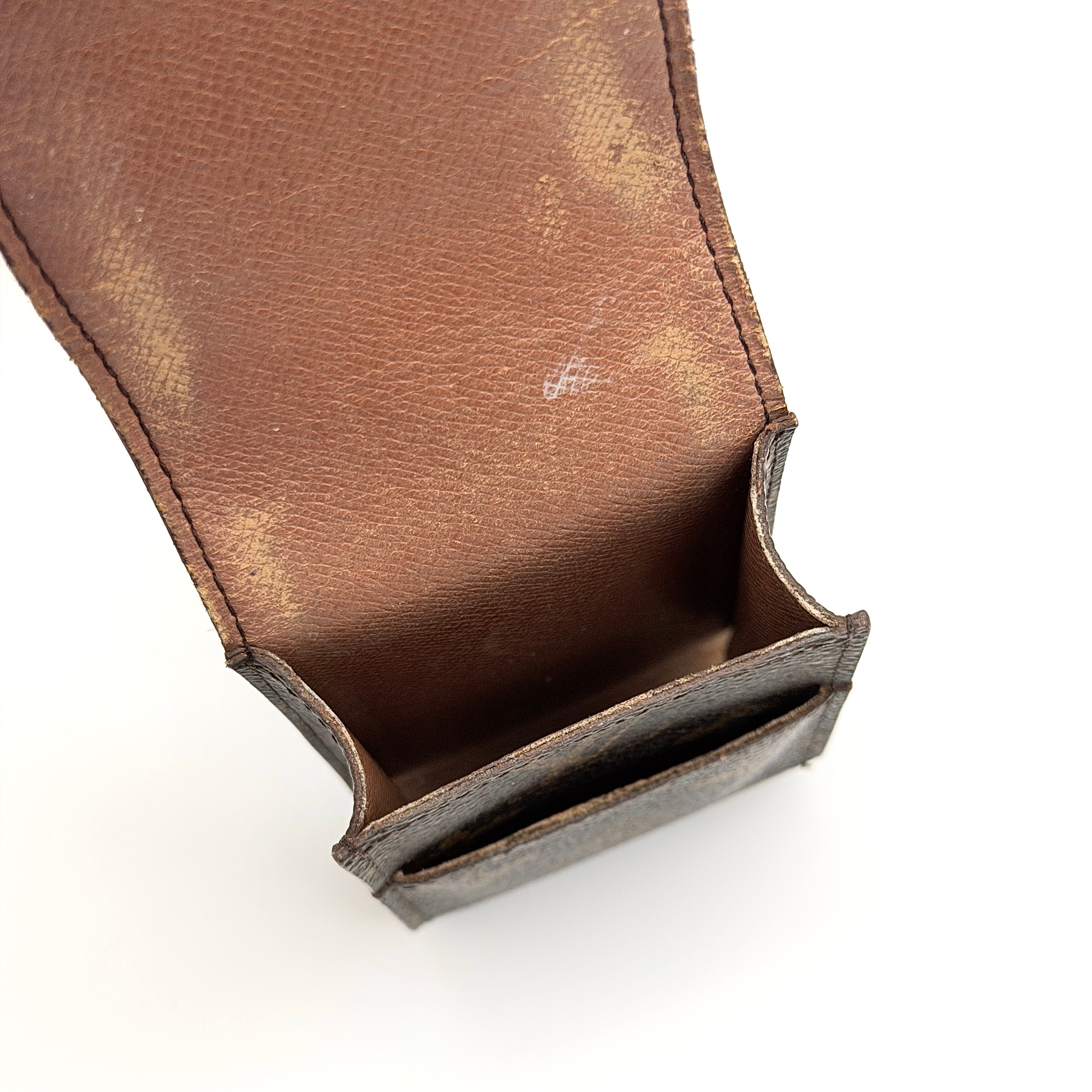 Louis Vuitton Monogram cigarette case in brown coated canvas with flap top, shown from the front.