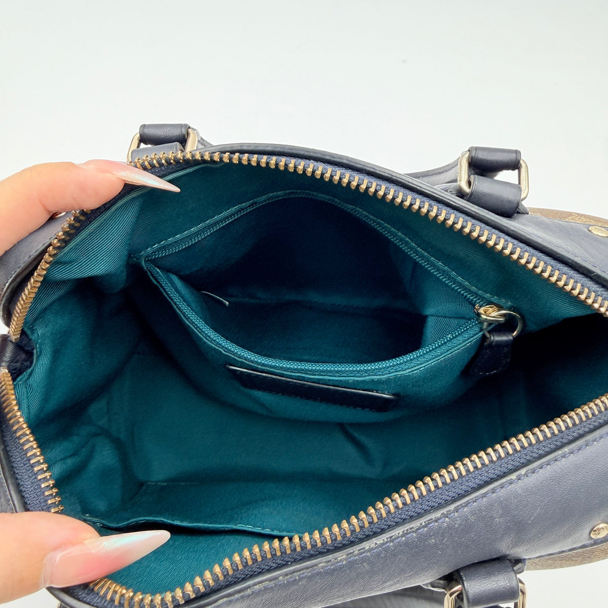 Coach Signature Mini Bennett Boston Bag in monogram canvas with navy and teal varsity stripes and dark navy leather trim.