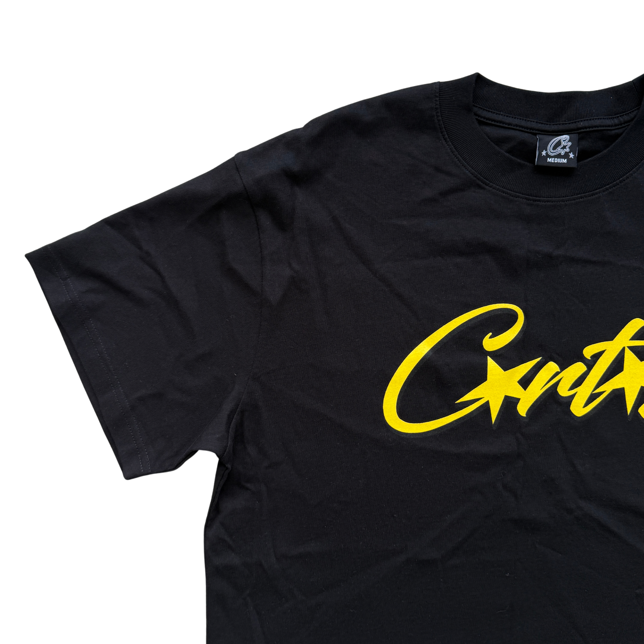 Corteiz Allstarz Tee in black with a bold yellow script logo across the chest, presented flat against a white background.