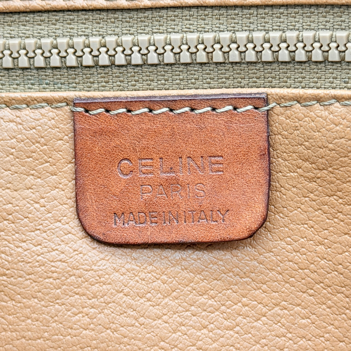 Celine Triomphe Macadam Clutch Bag in brown coated canvas with leather trim, photographed on a white background.