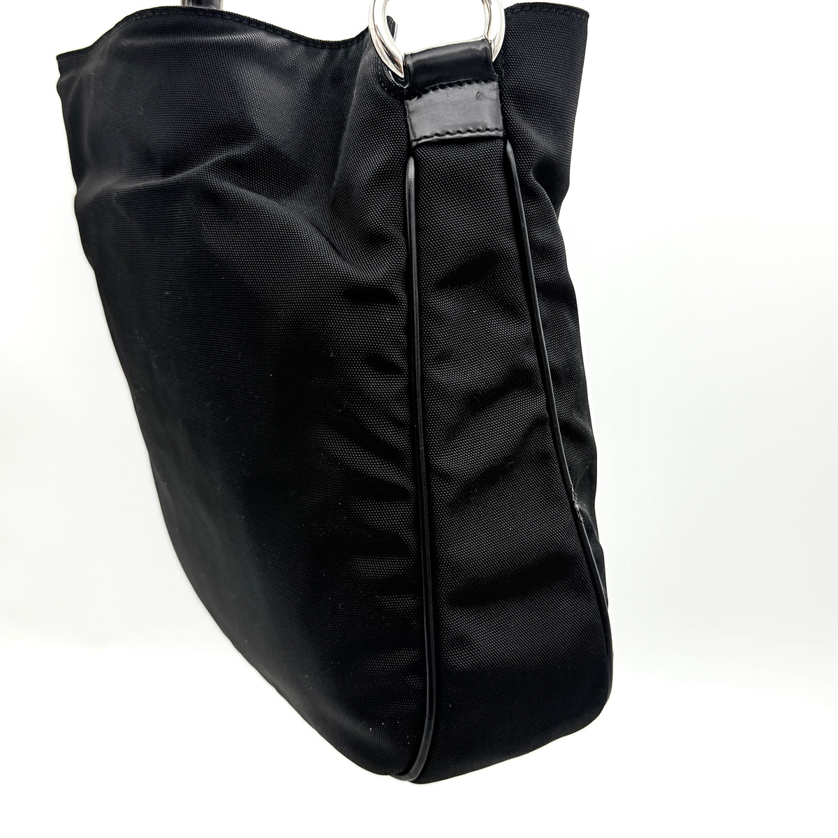 Gucci black nylon shoulder bag with bamboo handle and detachable strap shown with dust bag.