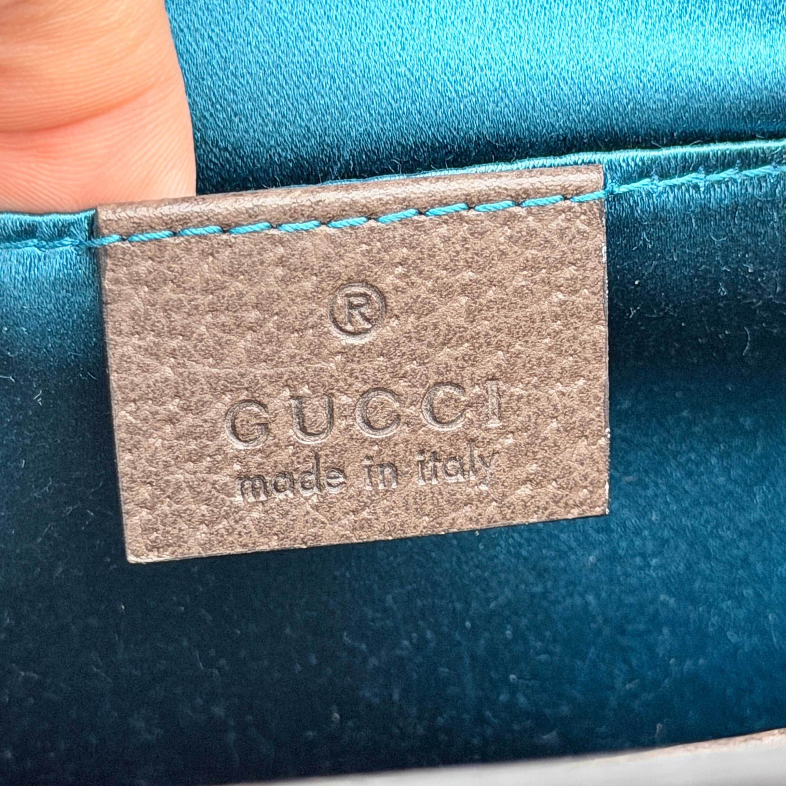 Gucci Ophidia GG Supreme crossbody bag in beige canvas with brown leather trim, signature web stripe, and gold chain strap.