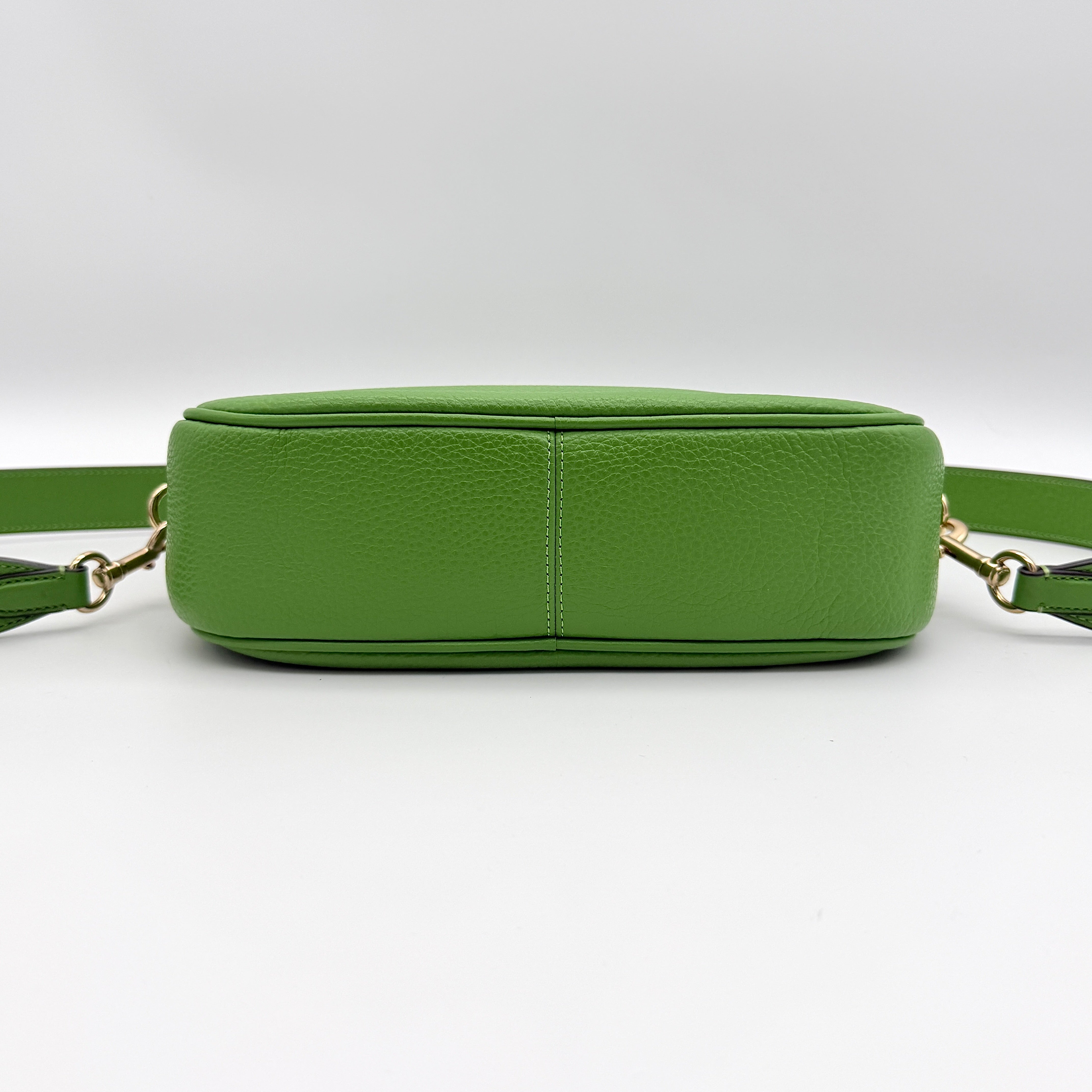 Coach Jamie Camera Crossbody Bag in green textured leather with gold-tone hardware and adjustable strap.