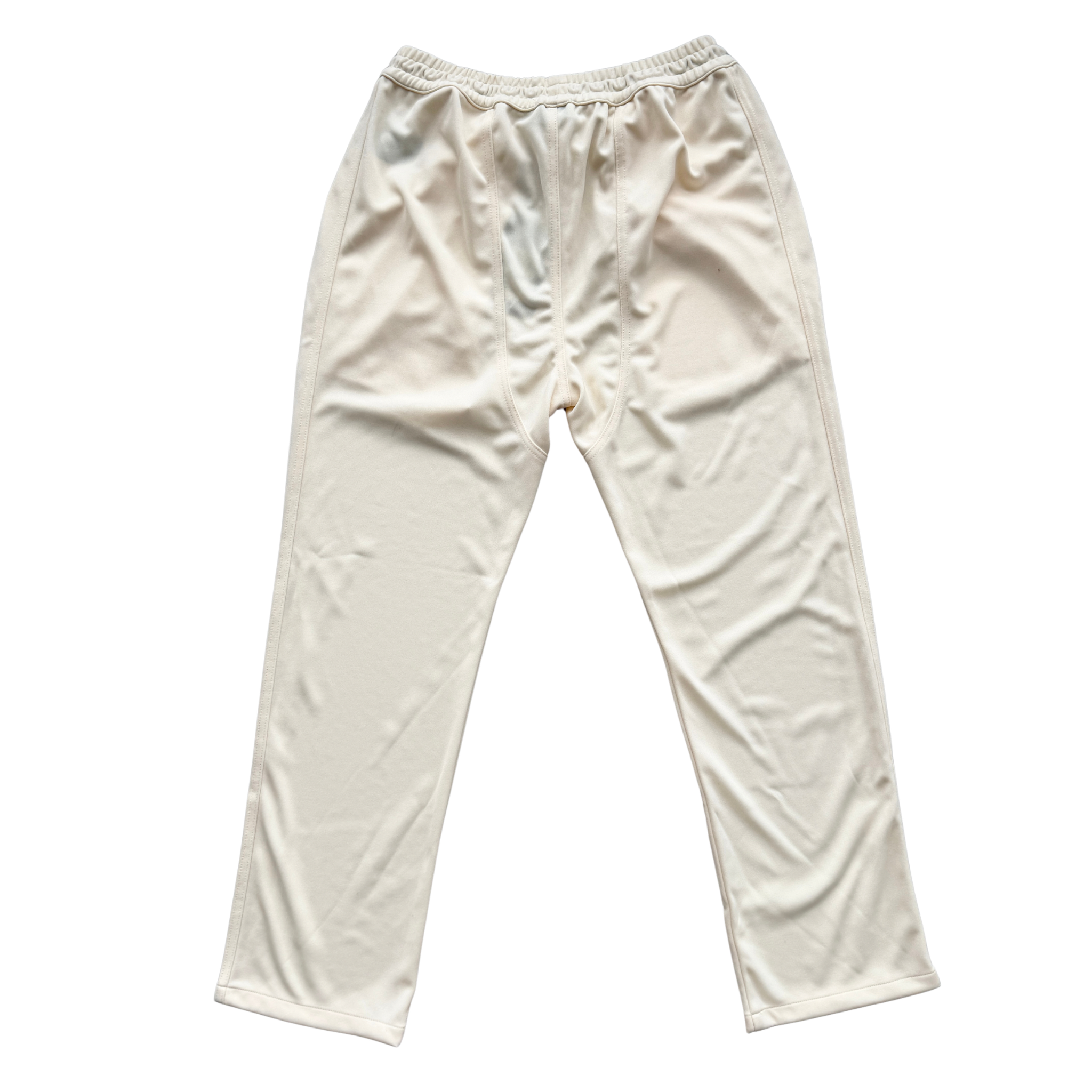 Rhude lounge track pants in cream with yellow drawstrings, displayed flat against a white background.