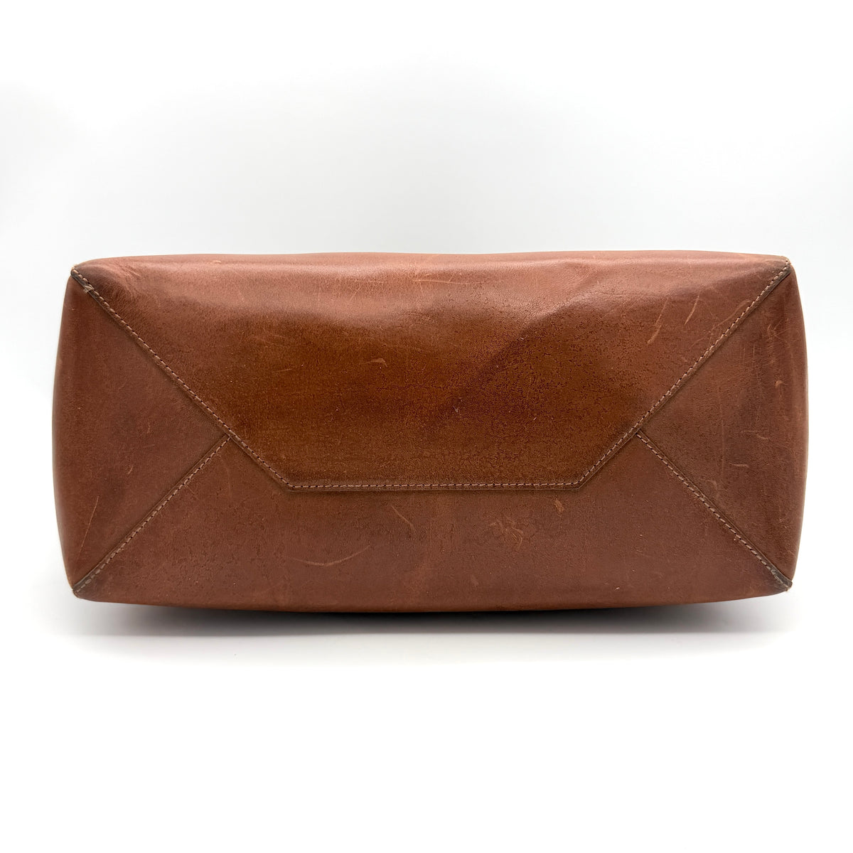 Celine Triomphe Macadam Canvas Tote Bag in beige and brown with leather trim and top handles, styled against a white background.