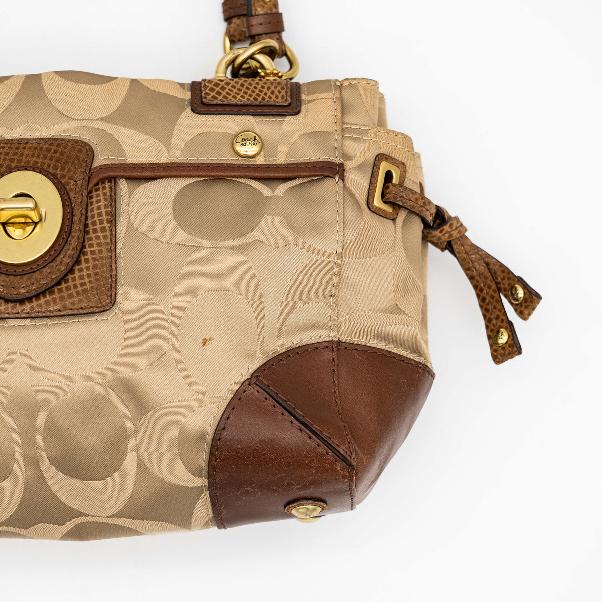Coach Signature Peyton Shoulder Bag in brown sateen and leather with gold-tone hardware and turnlock pocket, photographed on a white background.