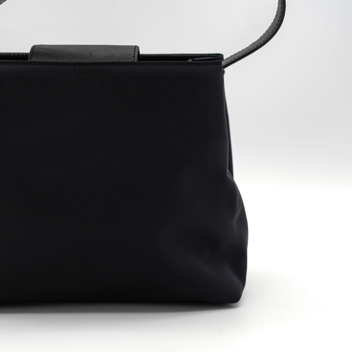 Coach Mercer tote bag in black nylon with leather handle and trim, presented against a white background.