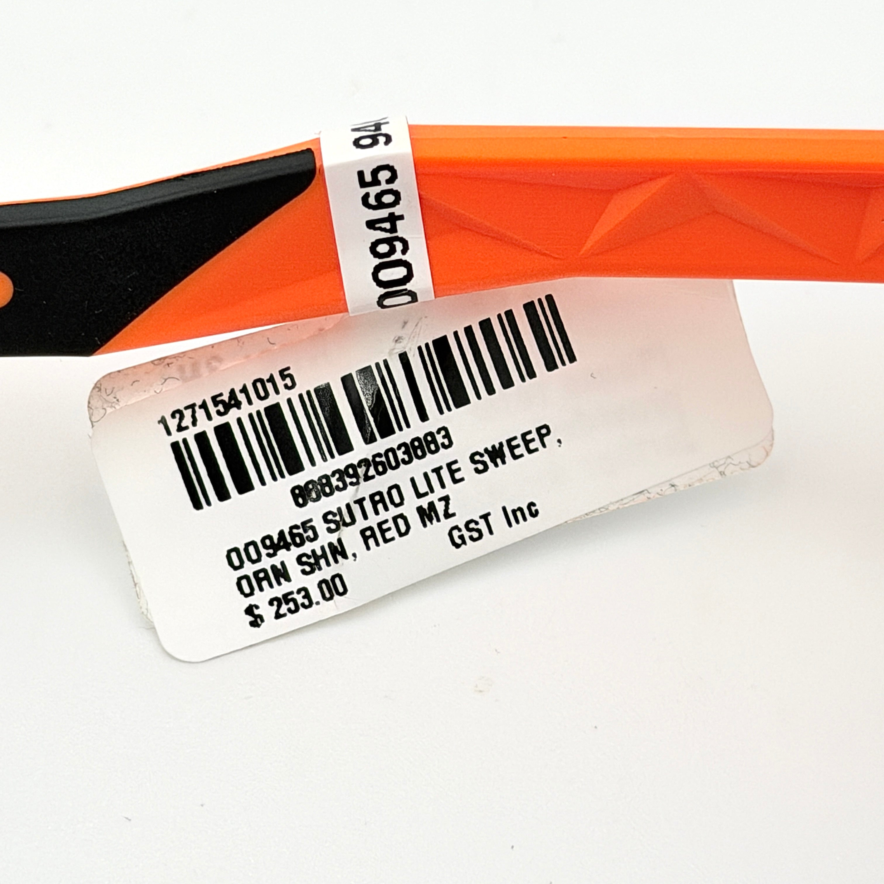 Oakley Sutro Lite Sweep MVDP Prizm Road sunglasses in orange sparkle with a shield lens and original pouch, photographed in bright studio lighting.