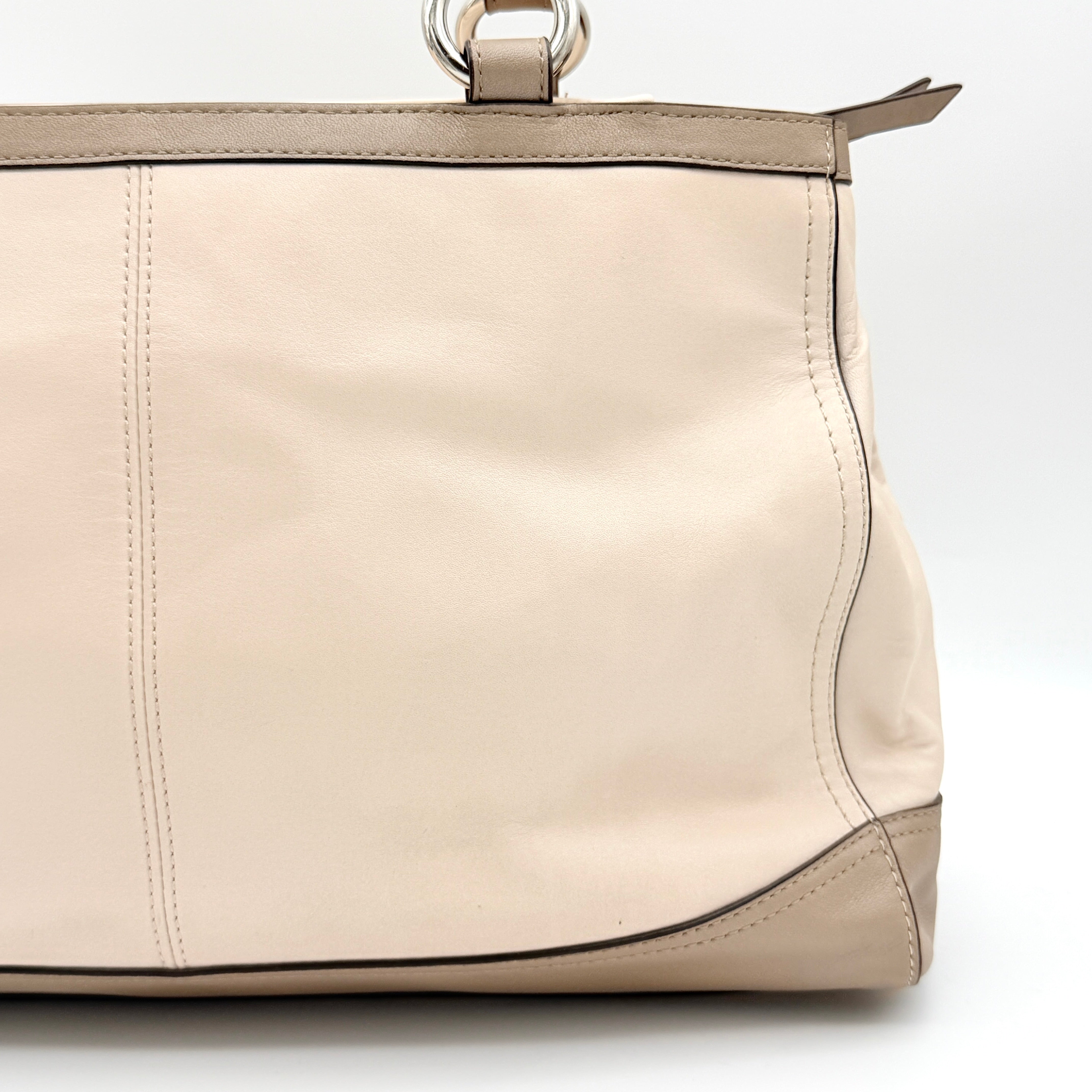 Coach Park Carryall shoulder bag in cream and grey leather with dual handles and silver hardware, photographed on a white background.