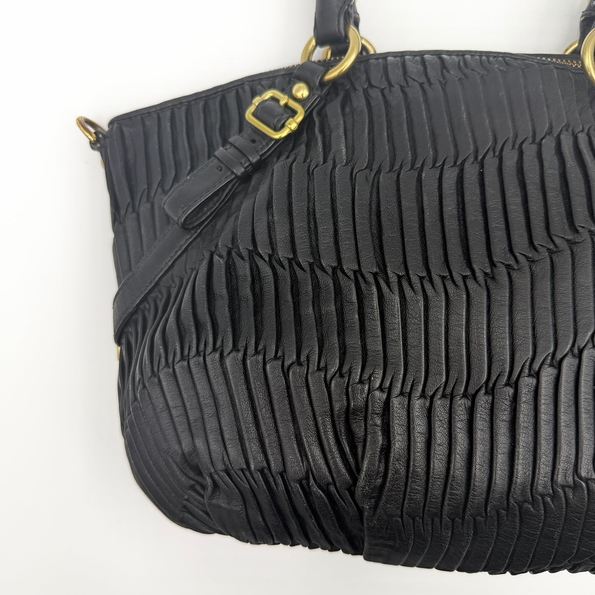 Coach Sophia Madison Pleated Shoulder Bag in black leather with gold hardware, displayed with detachable strap and dust bag.