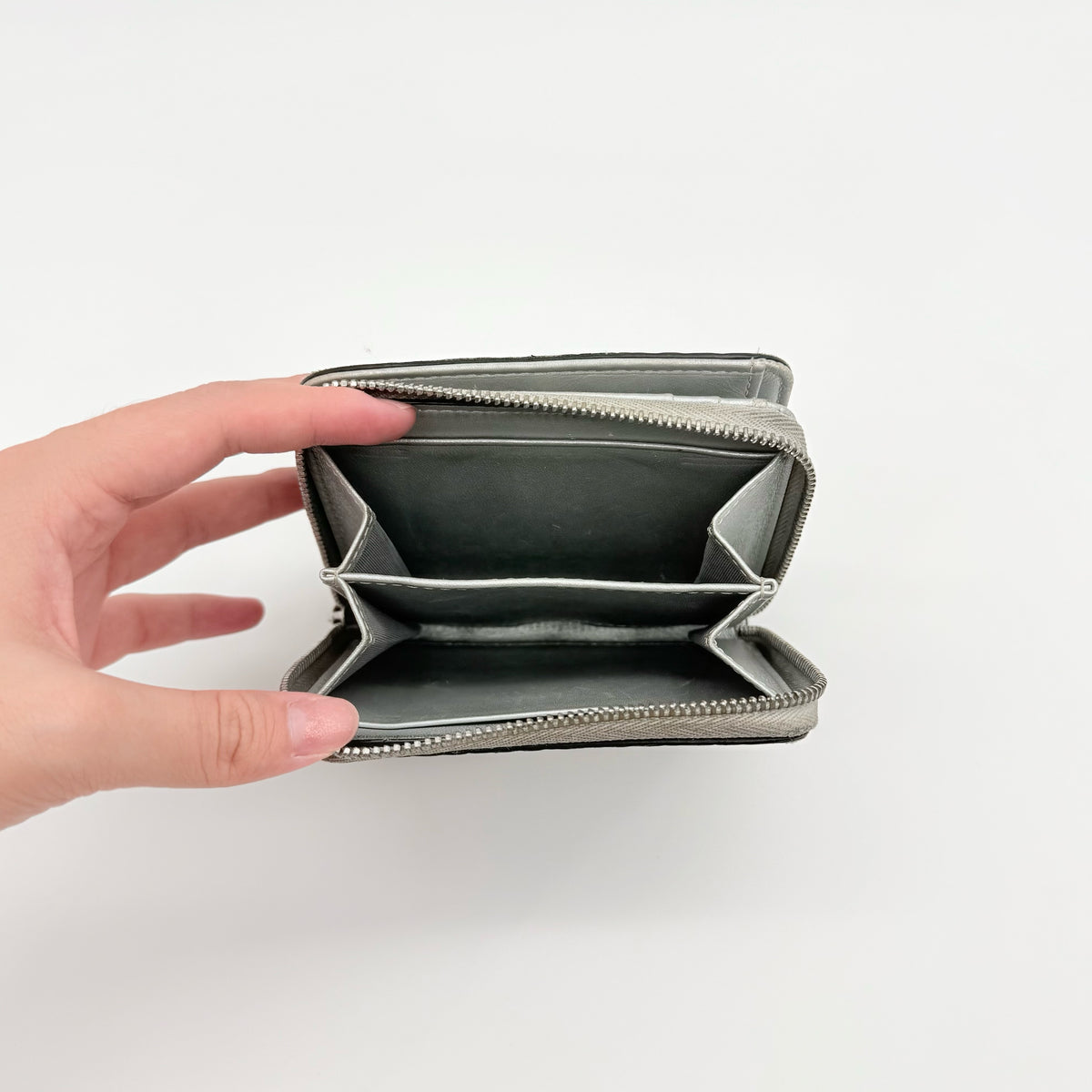 MCM Visetos Monogram wallet in metallic silver with black logo pattern on a clean white background.