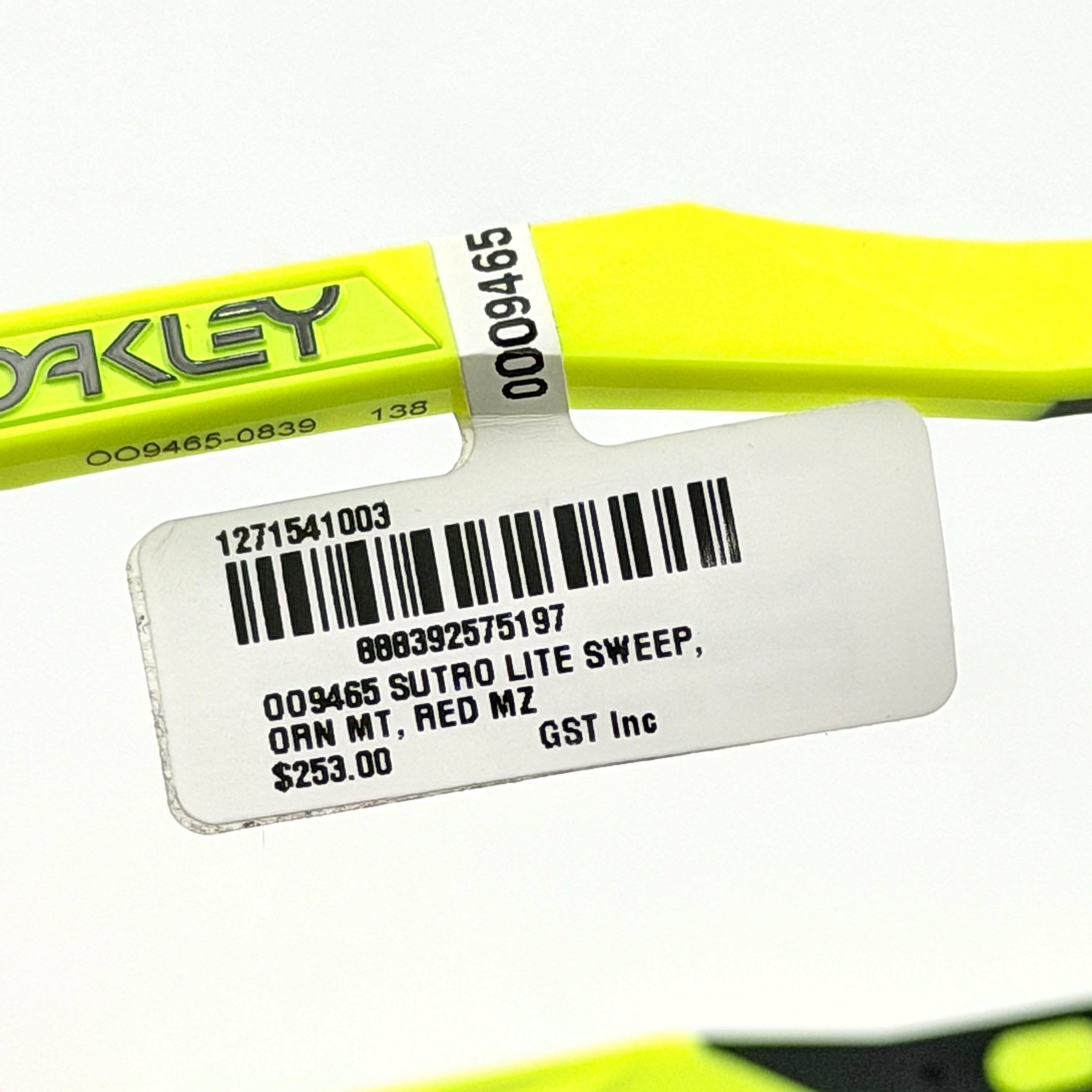 Oakley Sutro Lite Sweep sunglasses in neon yellow and orange with Prizm Trail Torch shield lens, displayed with box and case.