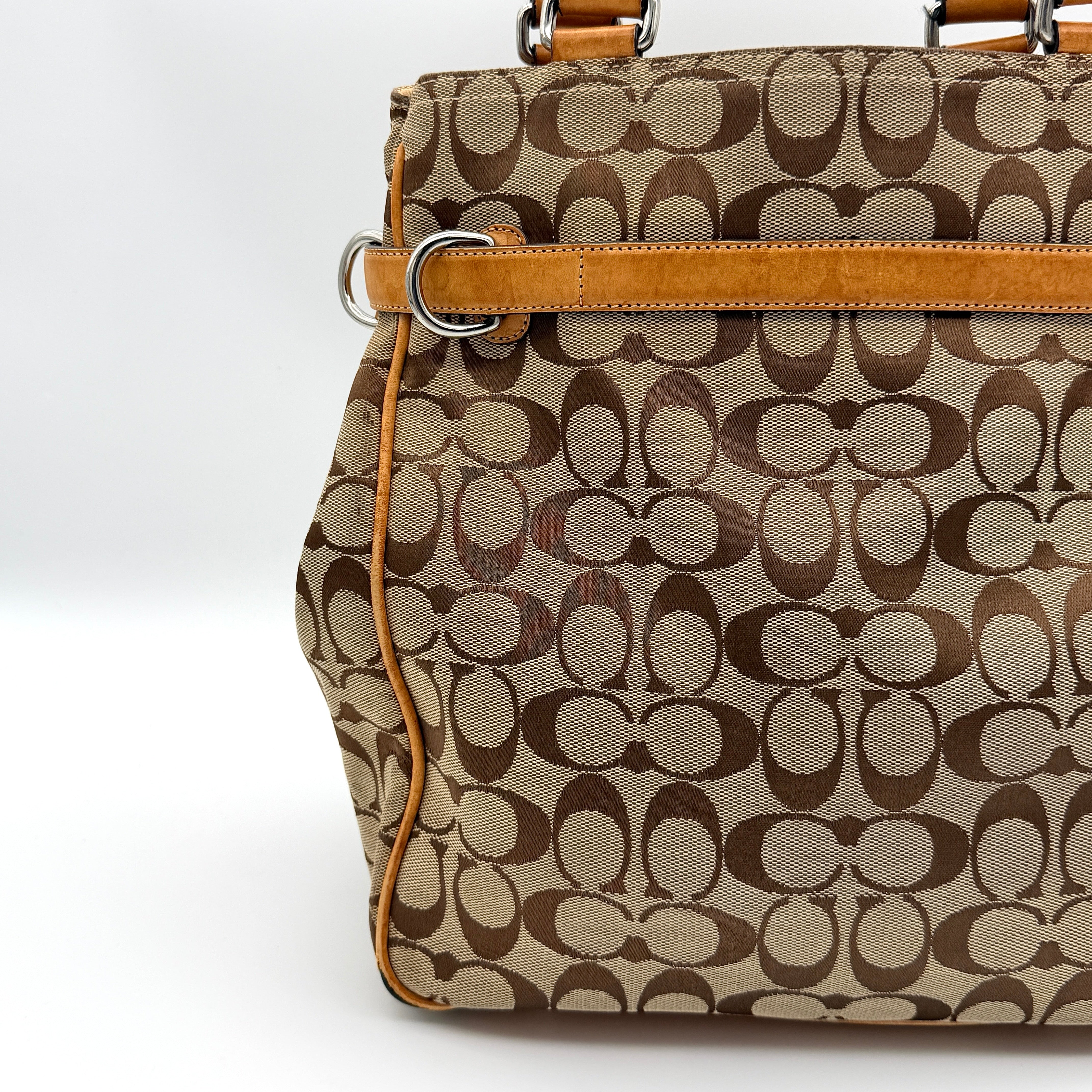 Coach Signature Buckle Tote Bag in beige and tan with signature canvas, tan leather trim, and silver-tone hardware.