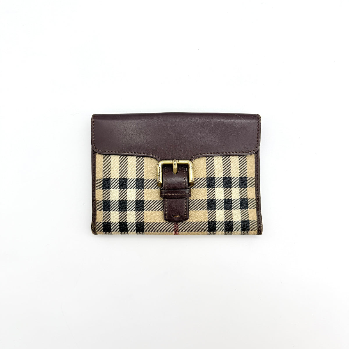 Burberry Nova Check wallet in beige and brown with leather trim and brass buckle detail photographed on white background.
