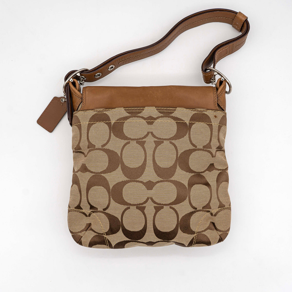 Coach 2Way Signature Soho Buckle Flap Shoulder Bag in beige and tan with silver buckle and adjustable leather strap, shown on a white background.