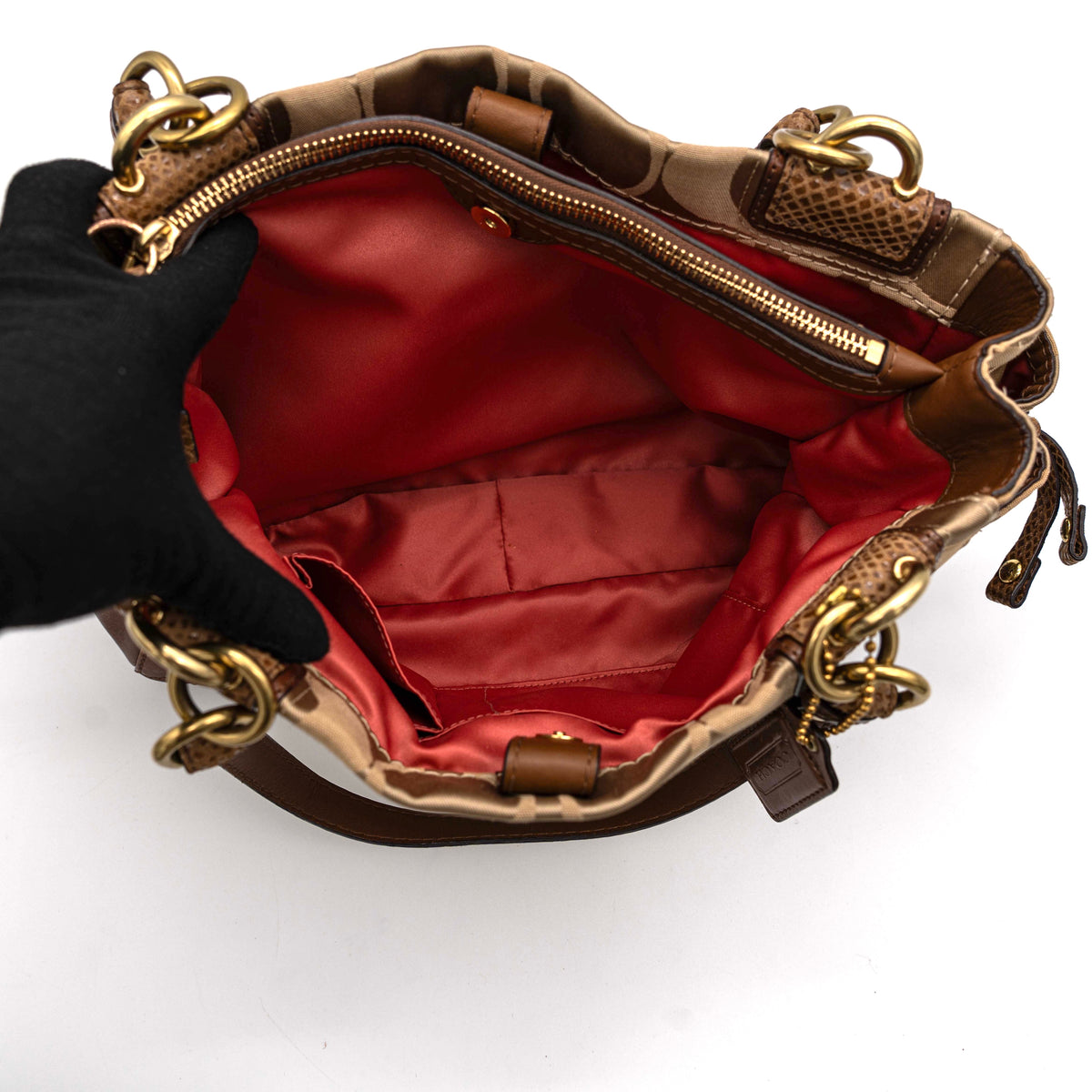 Coach Signature Peyton Shoulder Bag in brown sateen and leather with gold-tone hardware and turnlock pocket, photographed on a white background.