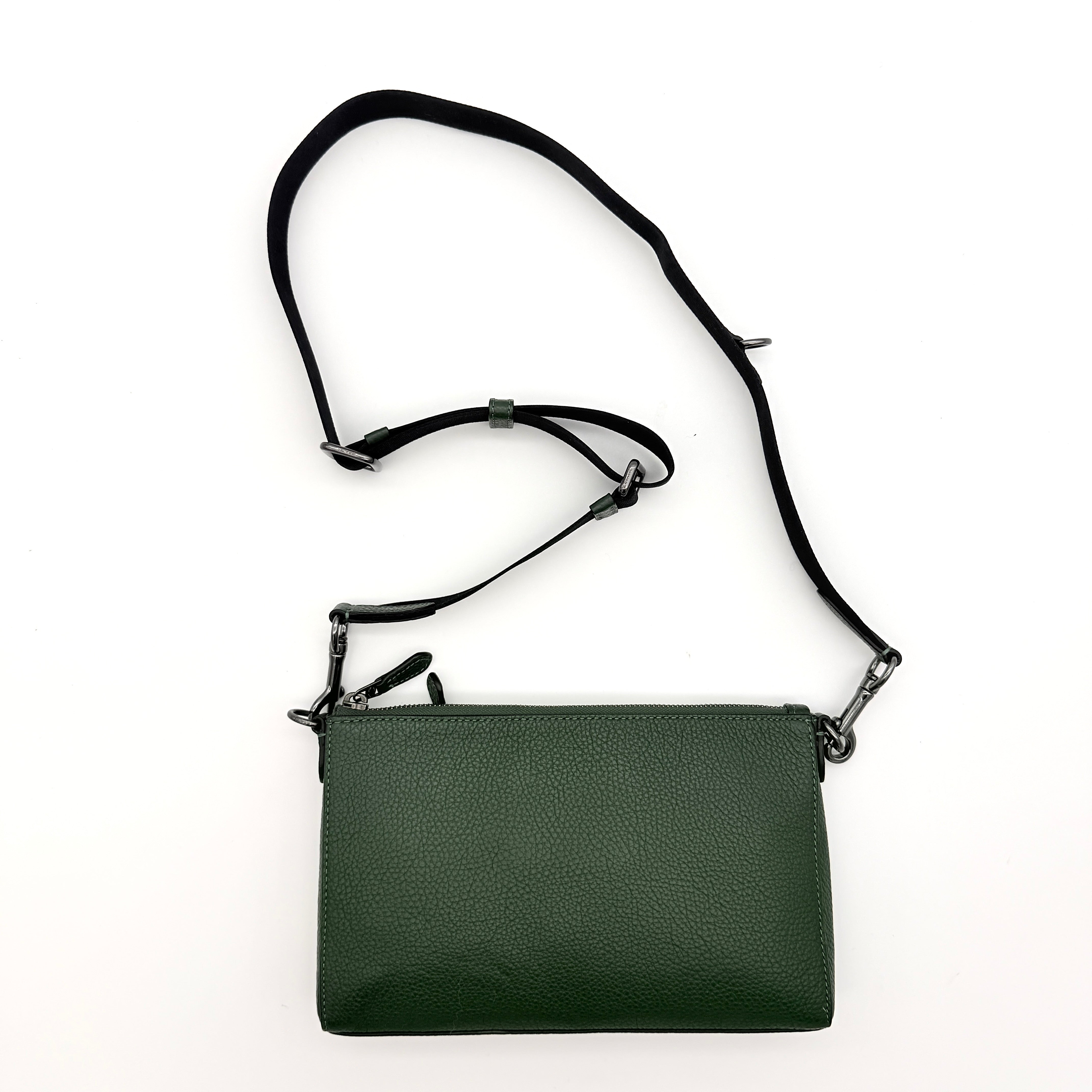 Coach Holden Crossbody bag in dark green pebbled leather with adjustable black webbing strap, displayed against a white background.