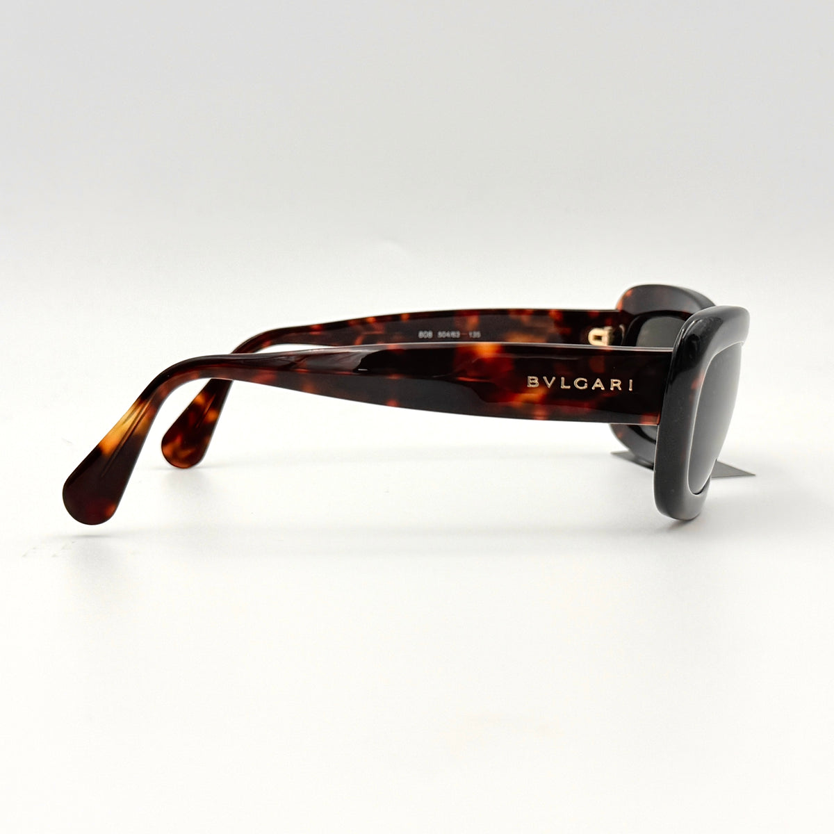 Bvlgari 808 sunglasses in tortoiseshell brown acetate displayed with original case and cloth.