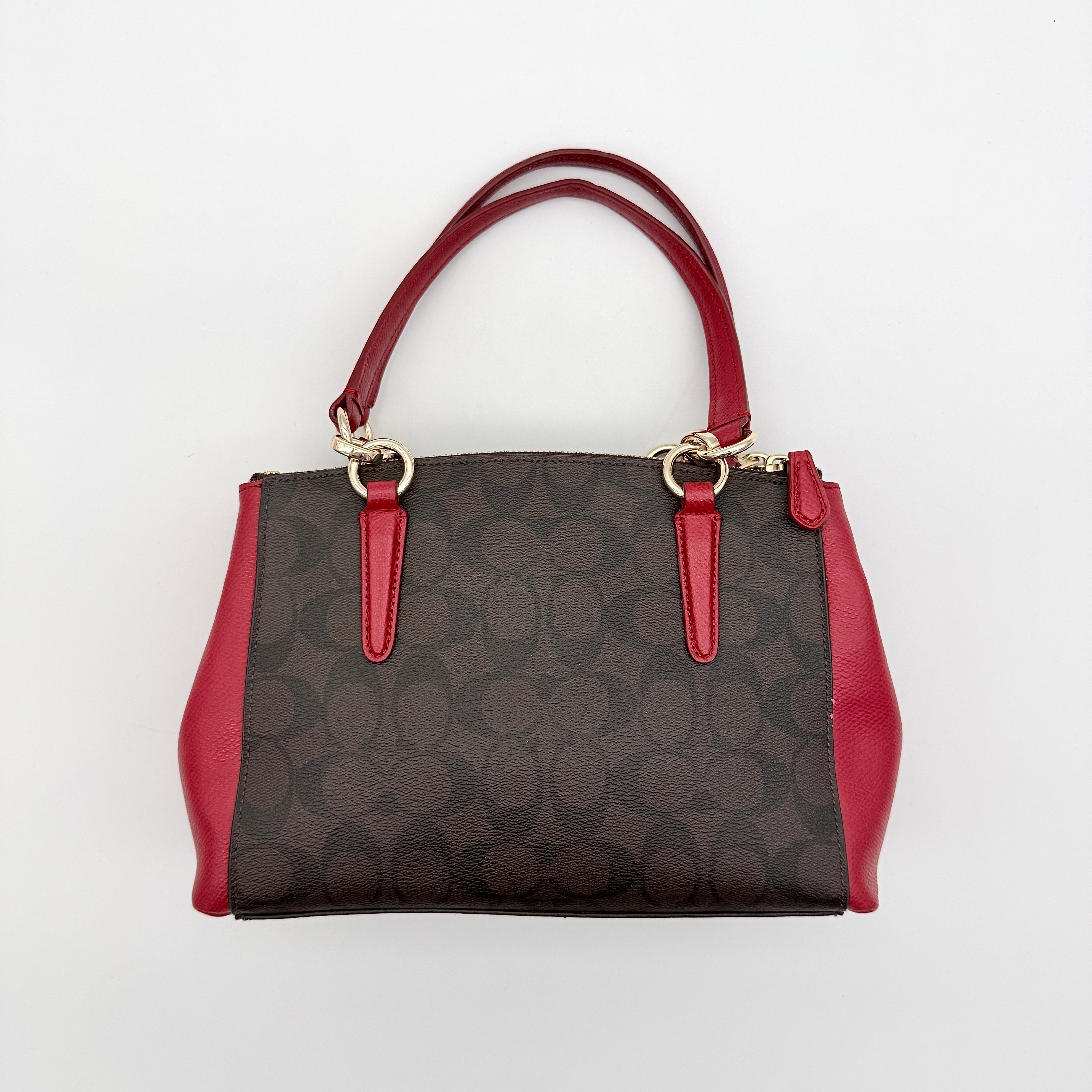 Coach 2Way Christie Carryall in brown coated canvas with red leather handles and sides, gold hardware, shown with detachable strap.
