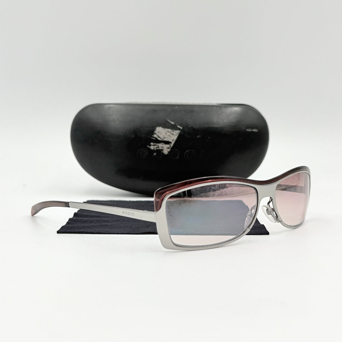 Gucci GG2689/S rectangle sunglasses in silver with pink gradient lenses, shown with case and cloth.