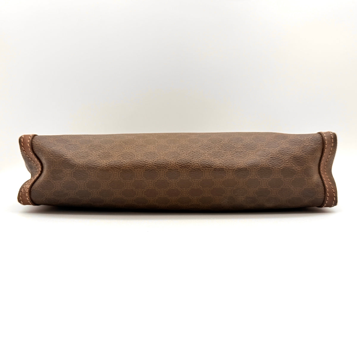 Celine Triomphe Macadam Clutch Bag in brown coated canvas with leather trim, photographed on a white background.