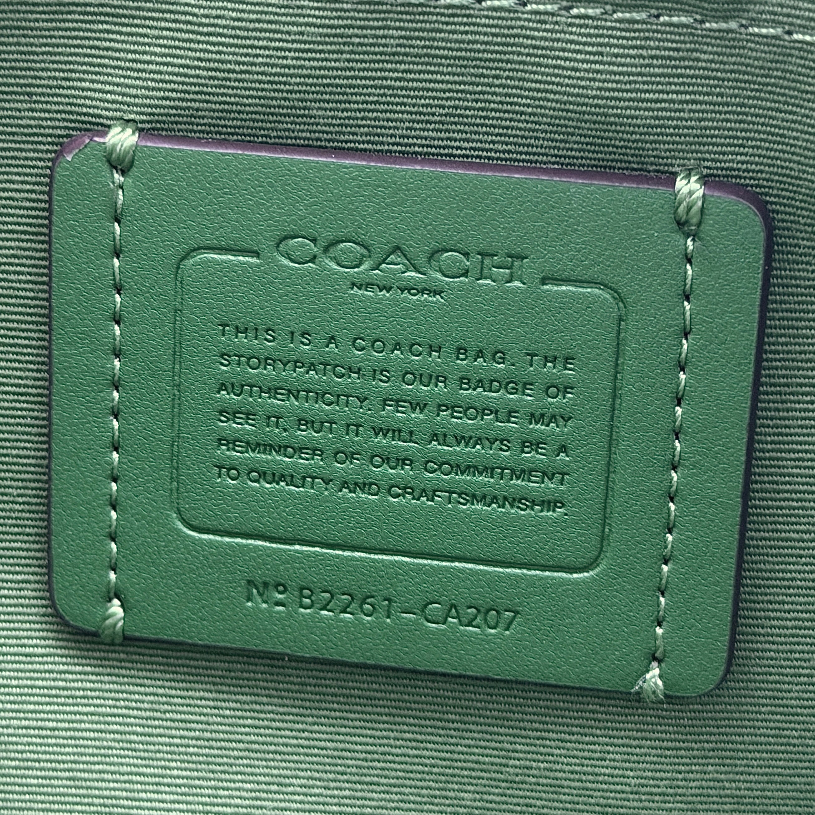 Coach Jamie Camera Crossbody Bag in green textured leather with gold-tone hardware and adjustable strap.