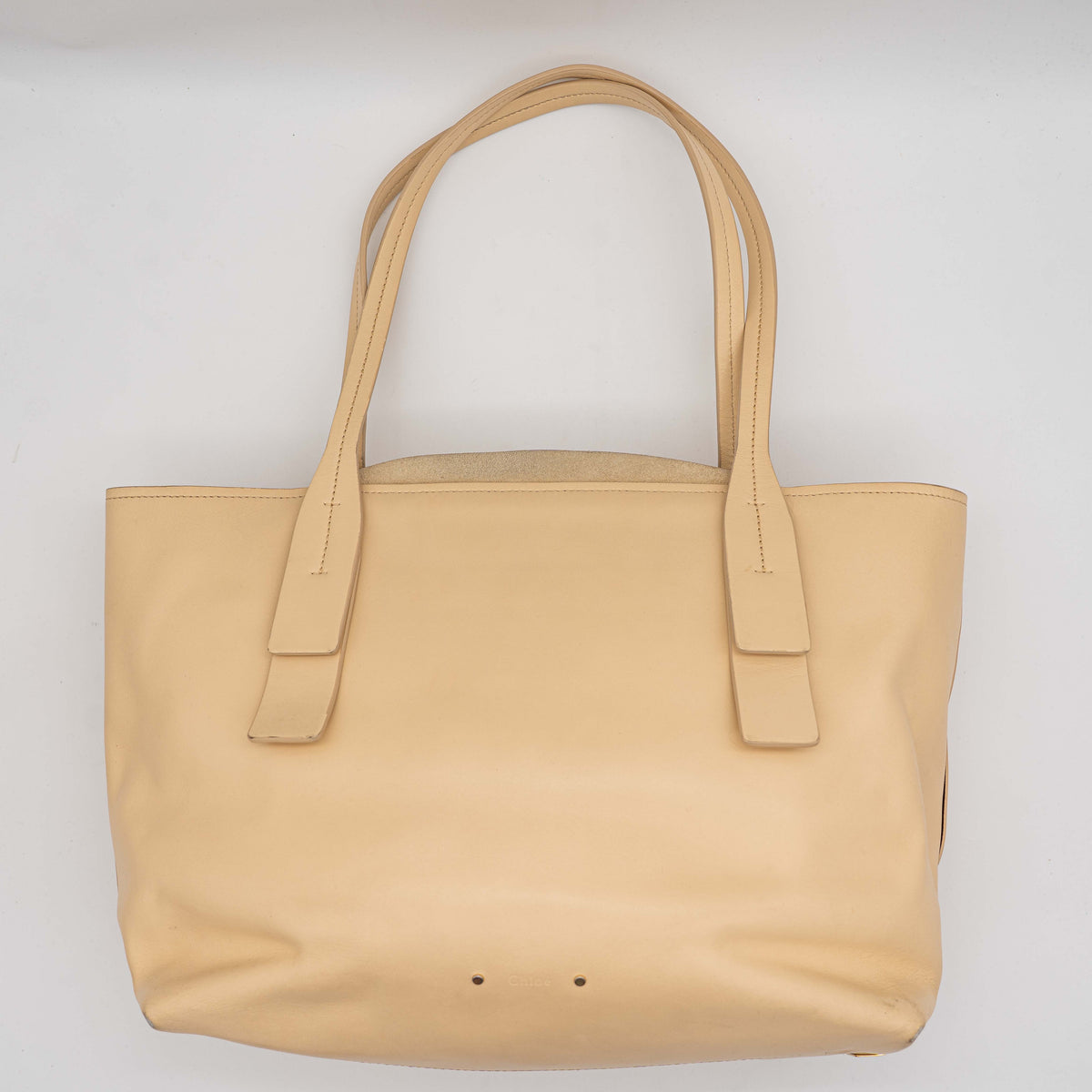 Chloé C Zipped Tote Bag in beige leather with gold hardware, shown with structured dual straps and front logo detail.