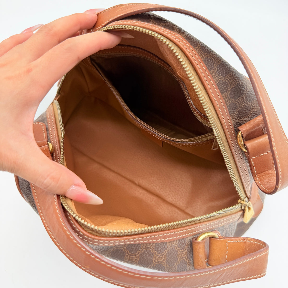 Front view of the Celine Triomphe Macadam Dome Handbag in brown, featuring the signature monogram canvas and tan leather details.