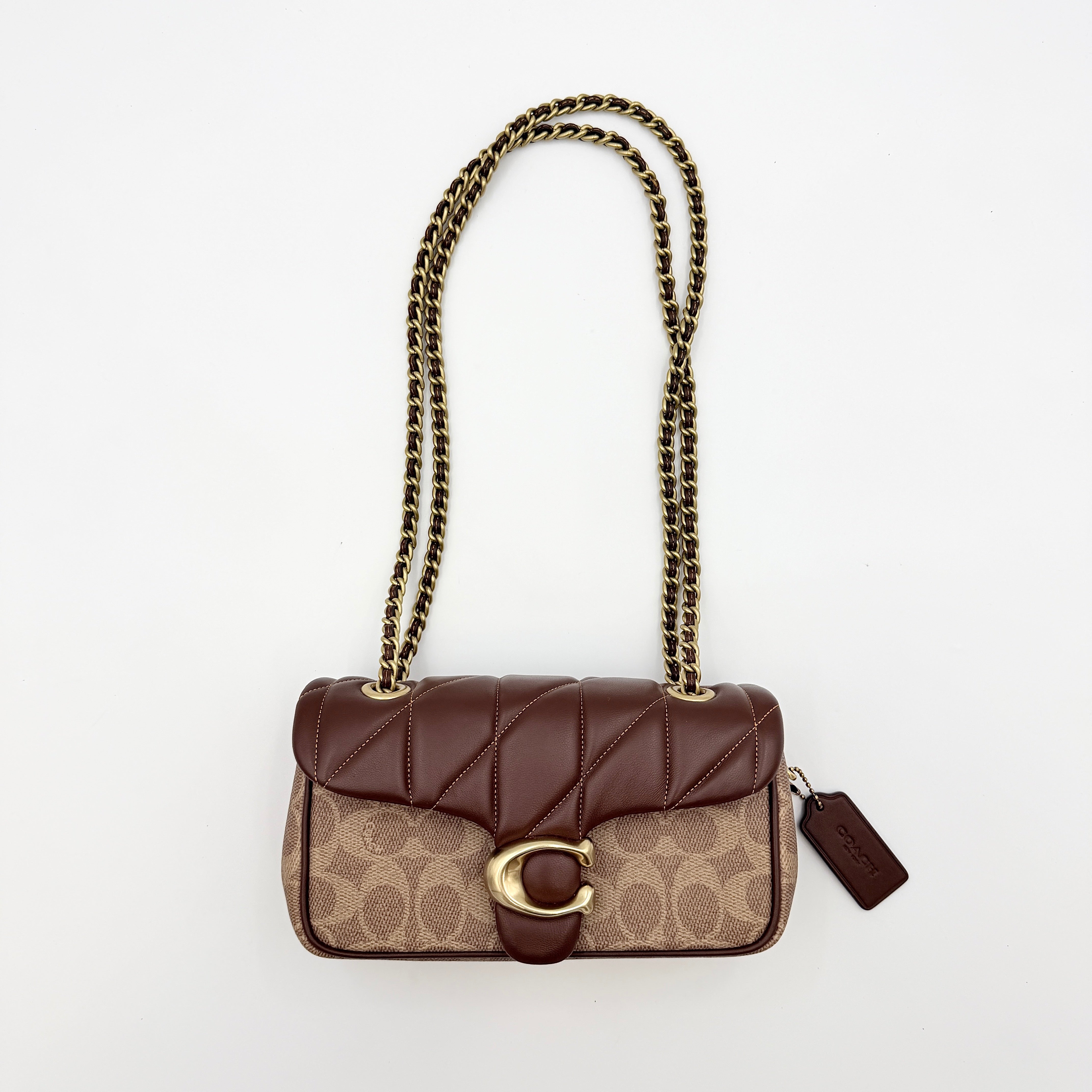 Coach Signature Quilted Tabby Shoulder Bag in brown monogram canvas with gold chain strap and oversized C clasp.