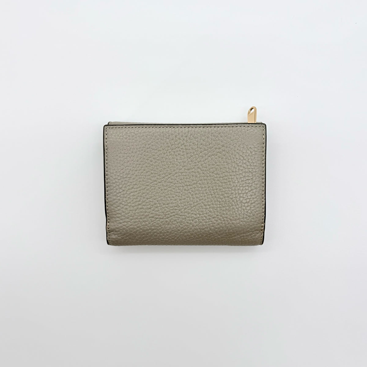Furla Dafne Trifold Wallet in grey pebbled leather with gold-tone hardware and trifold interior, shown with original dust bag.
