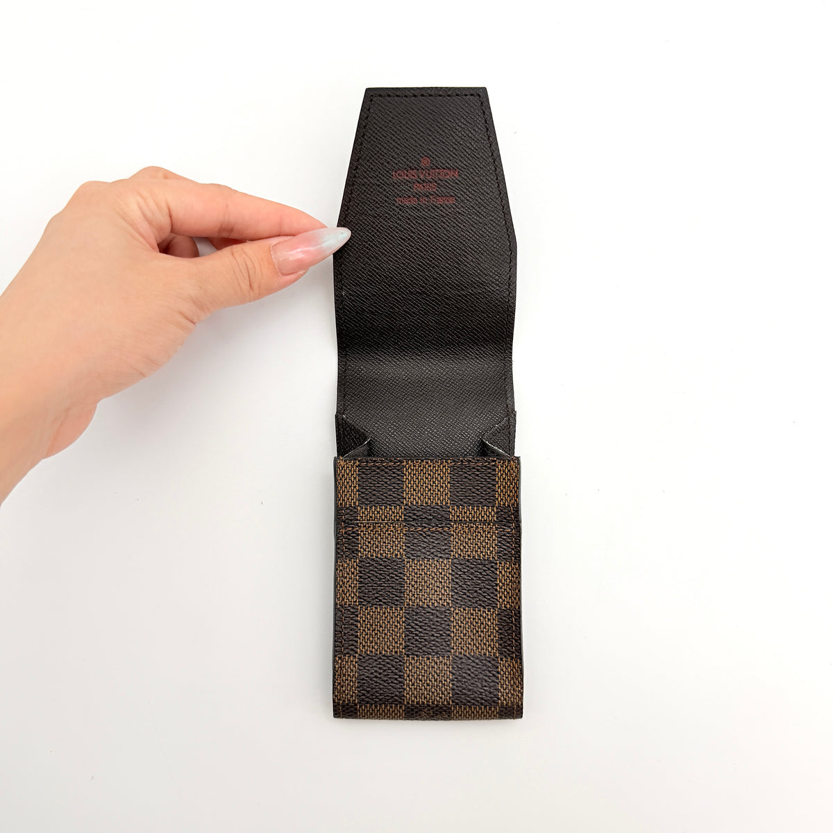 Louis Vuitton Damier Ebene canvas cigarette case with flap closure in brown, shown on a white background.