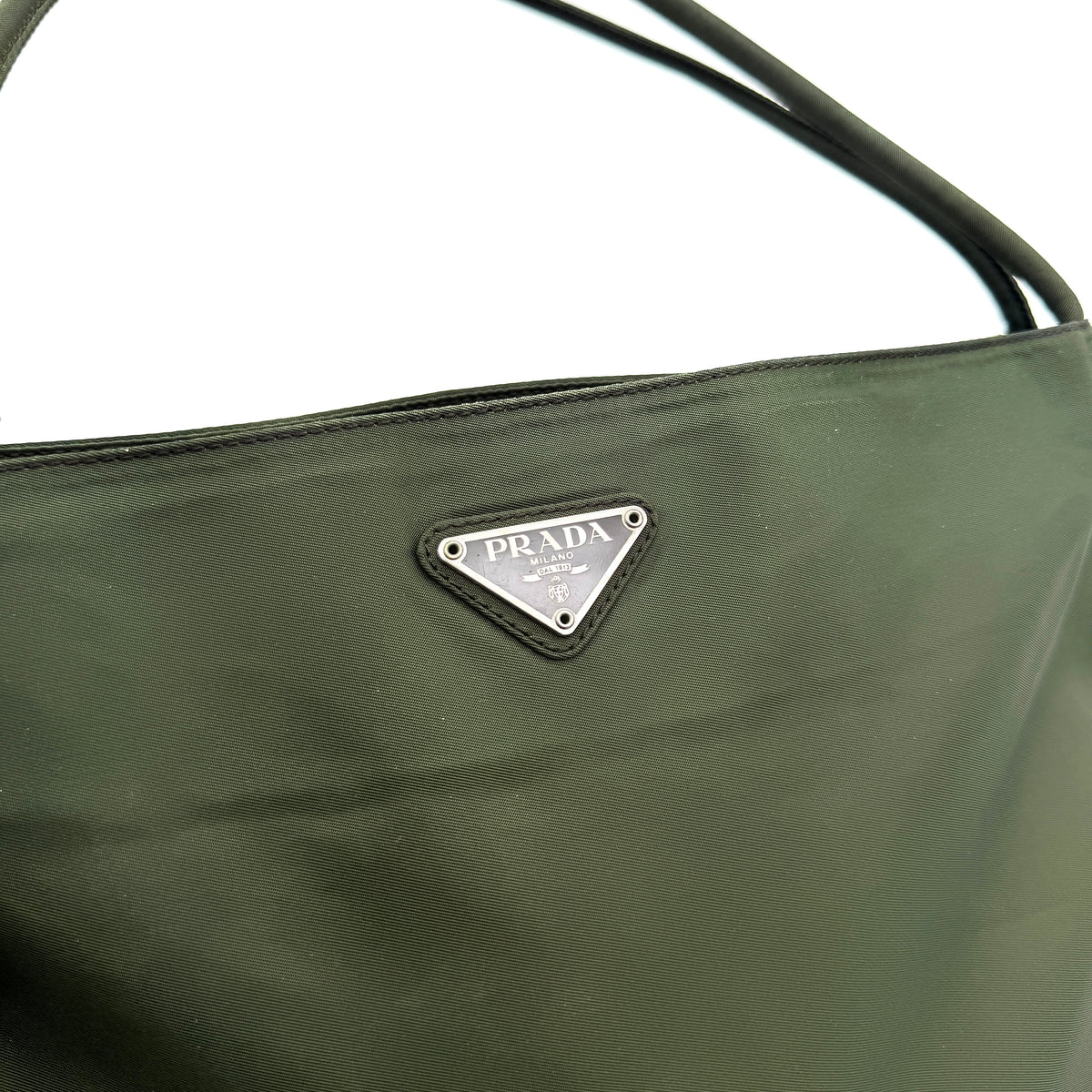 Prada Tessuto Nylon City Tote Bag in dark green nylon with double handles and signature triangle logo plaque on the front.