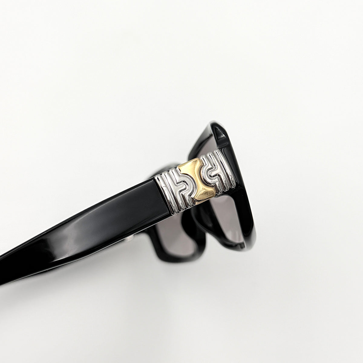 Bvlgari 829 501/11 black sunglasses with silver and gold temple hardware, displayed with case and cleaning cloth.