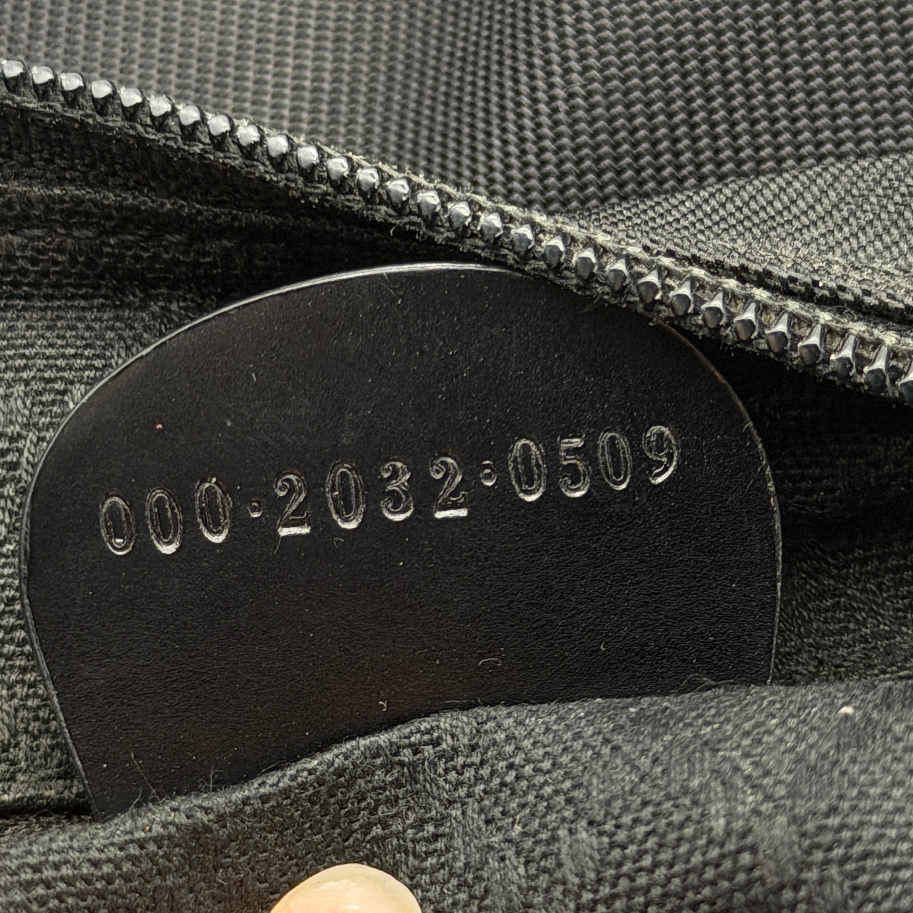 Gucci nylon shoulder bag in black with bamboo handle, shown against a white background.