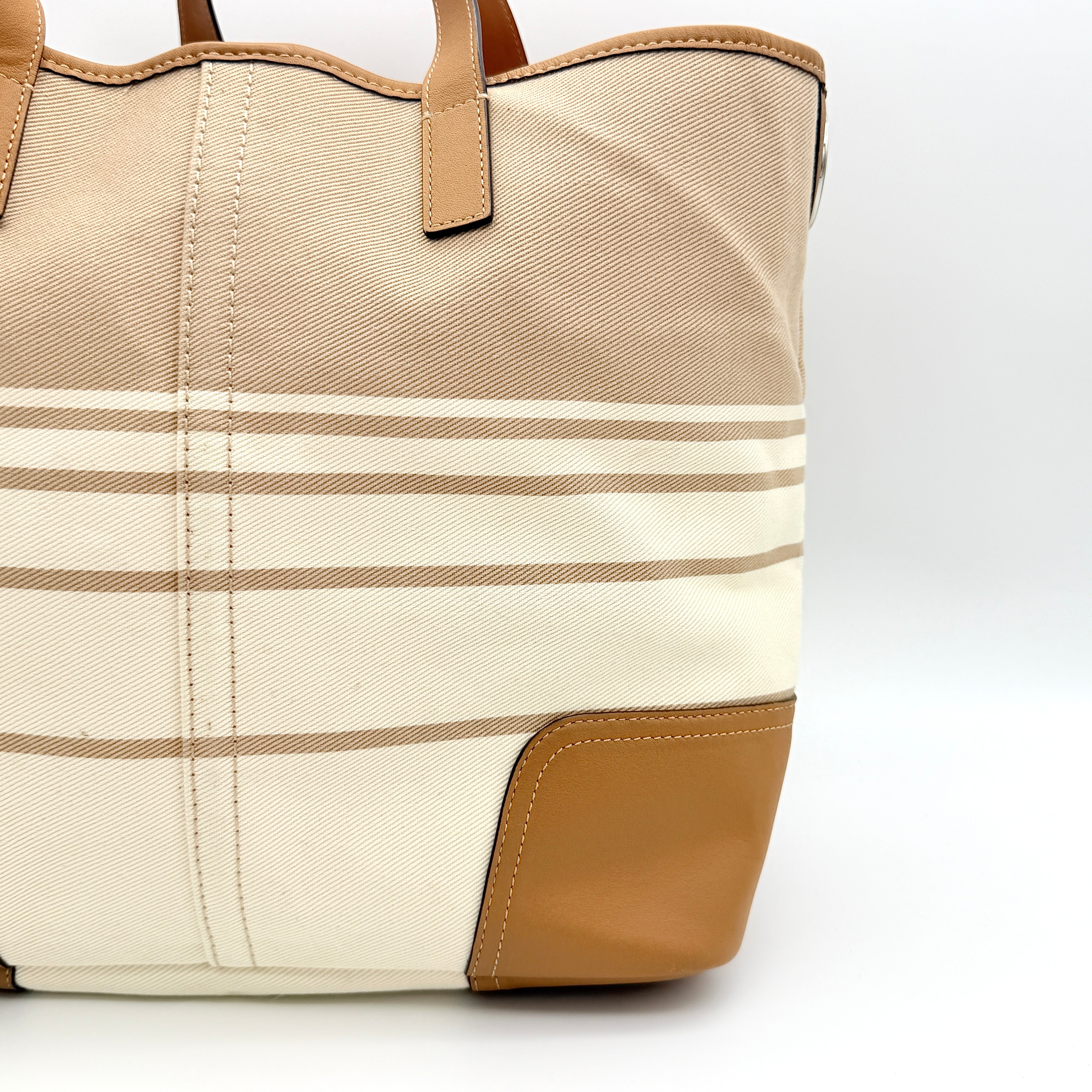 Coach Hadley Variegated Stripe Handbag in beige and tan canvas with leather trim, shown with top handles and detachable strap.