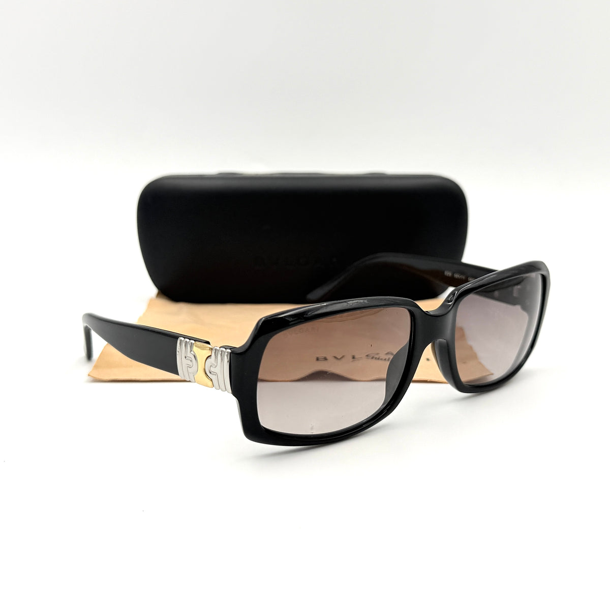Bvlgari 829 501/11 black sunglasses with silver and gold temple hardware, displayed with case and cleaning cloth.