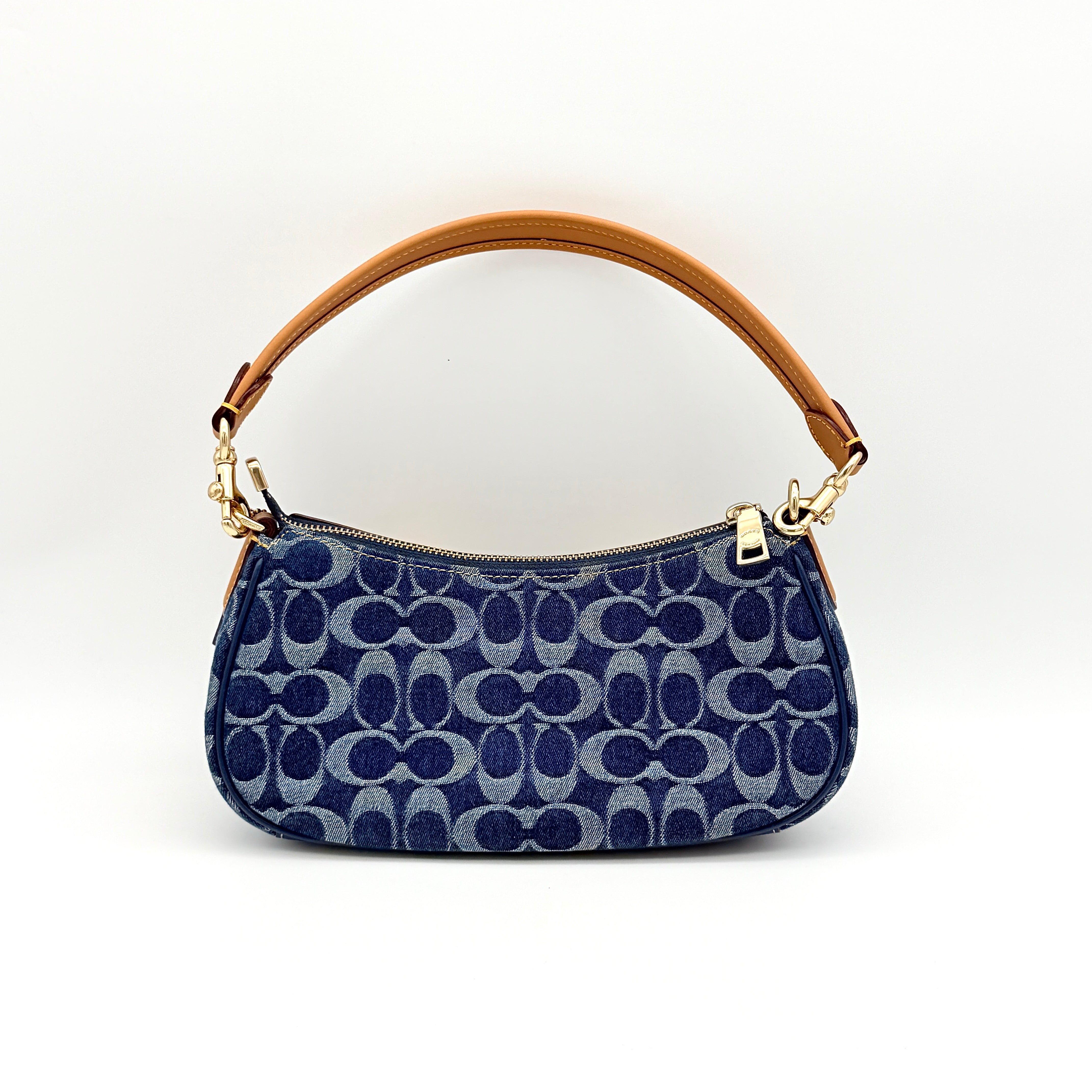 Coach Signature Ashton shoulder bag in blue denim and tan leather with gold hardware, shown with removable strap and dust bag.