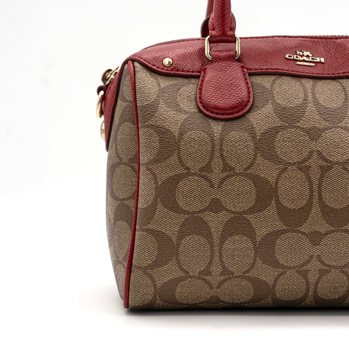 Coach Mini Bennett Boston bag in signature beige canvas with red leather trim, shown with detachable crossbody strap.