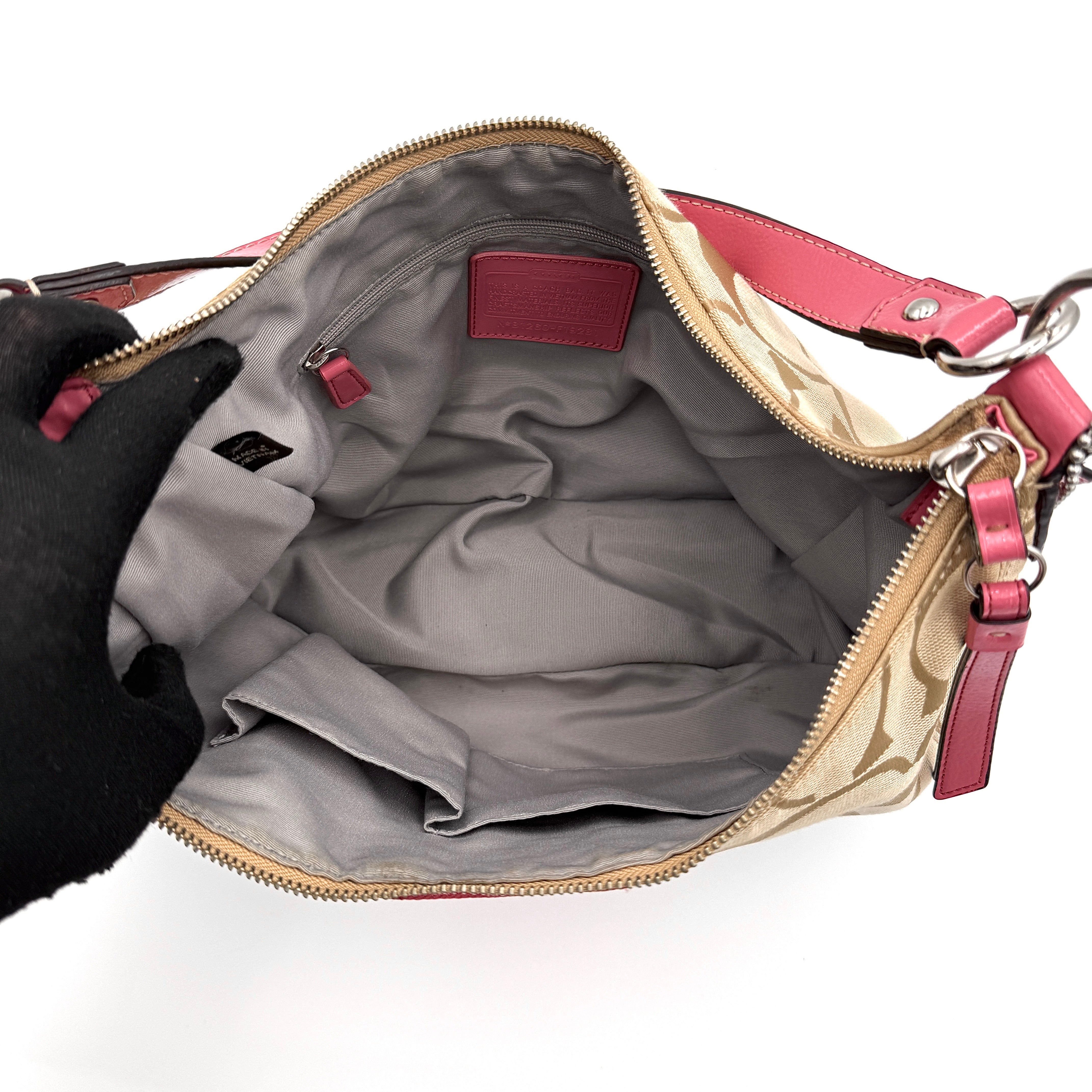 Coach Signature Stripe Hobo Shoulder Bag in beige jacquard canvas with bold pink central stripe and pink leather shoulder strap.