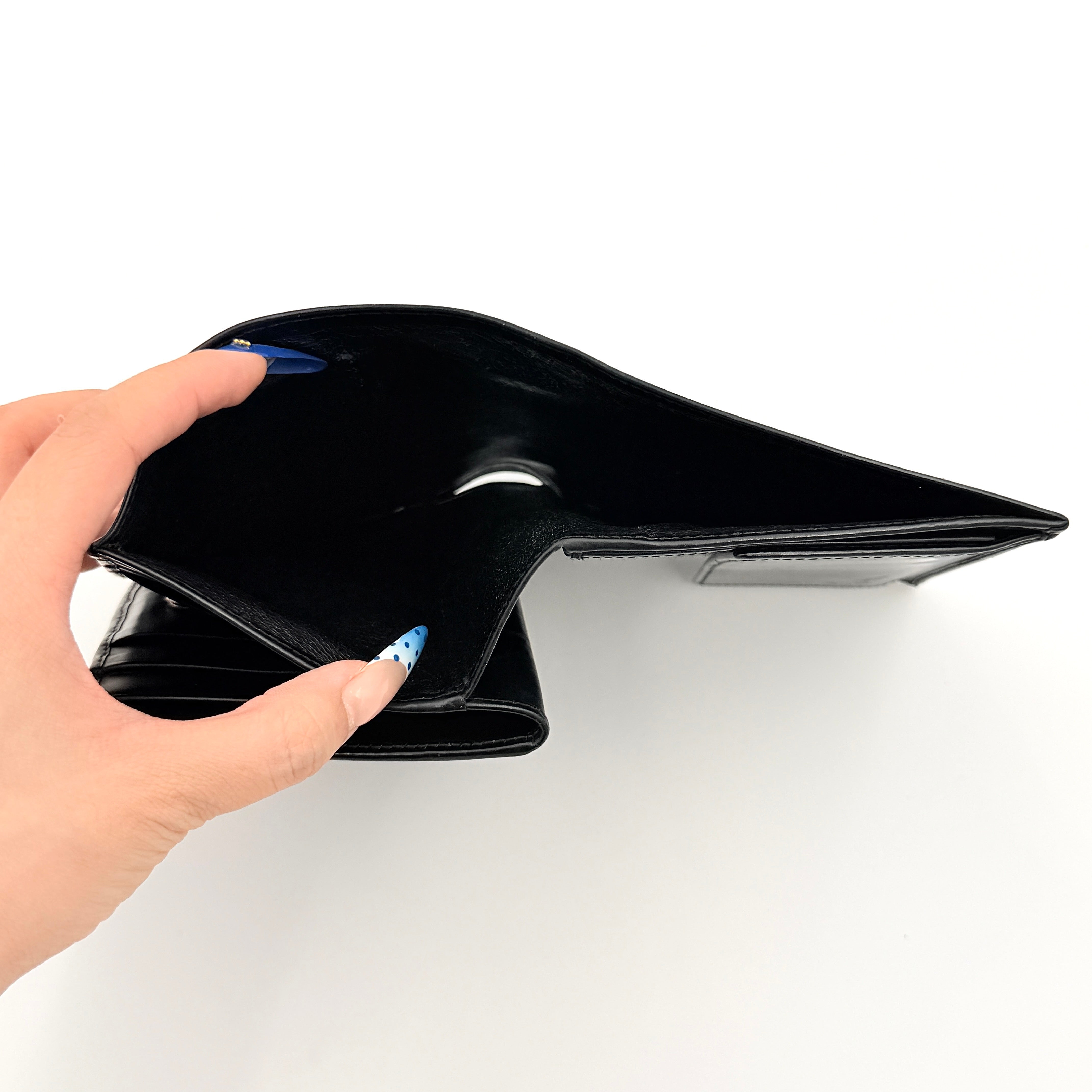 Gucci G Logo Bifold Wallet in black leather featuring a bold geometric G plaque and meticulously stitched edges.