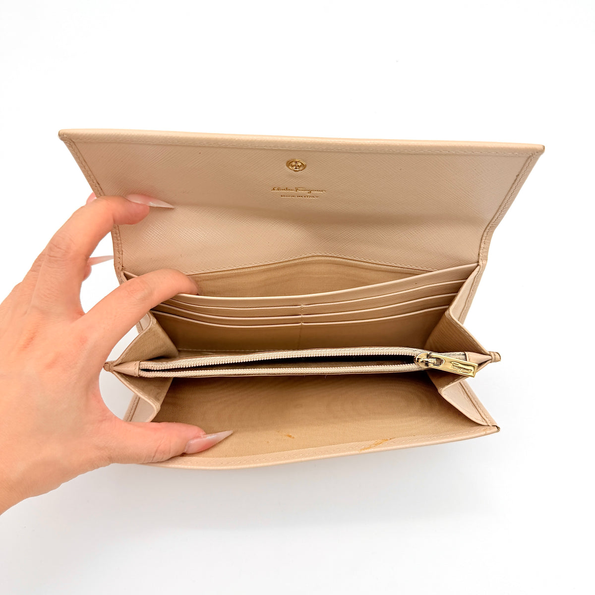 Salvatore Ferragamo light pink Saffiano wallet with gold Gancini hardware, shown on a white background.