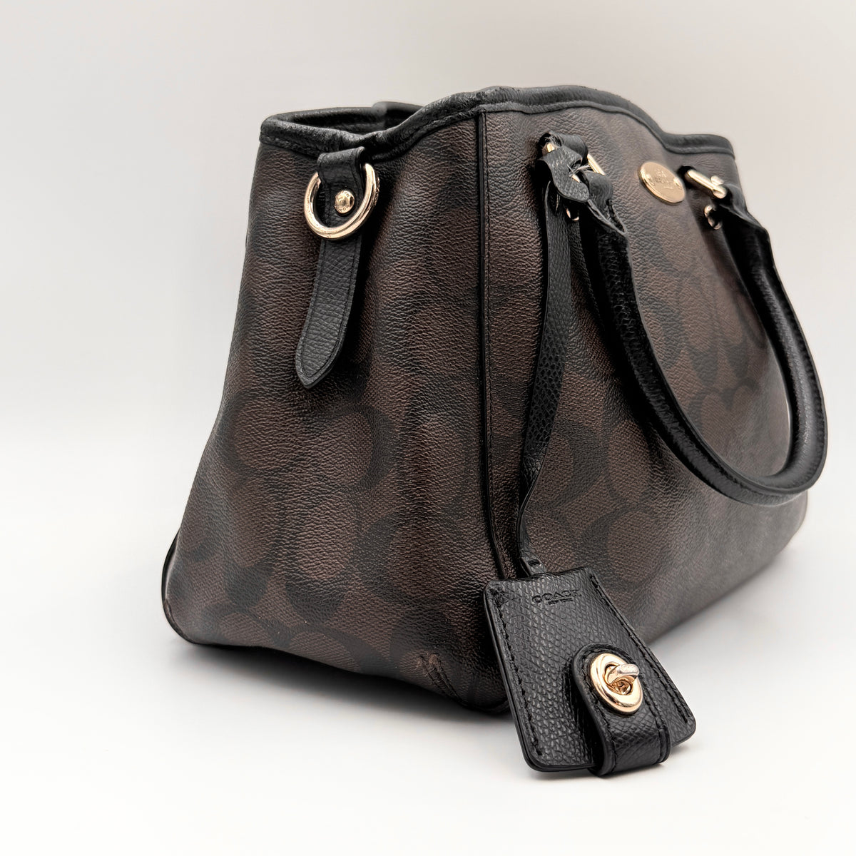 Coach 2Way Signature Margot Carryall Satchel in brown with black leather handles and gold hardware, shown with detachable strap.