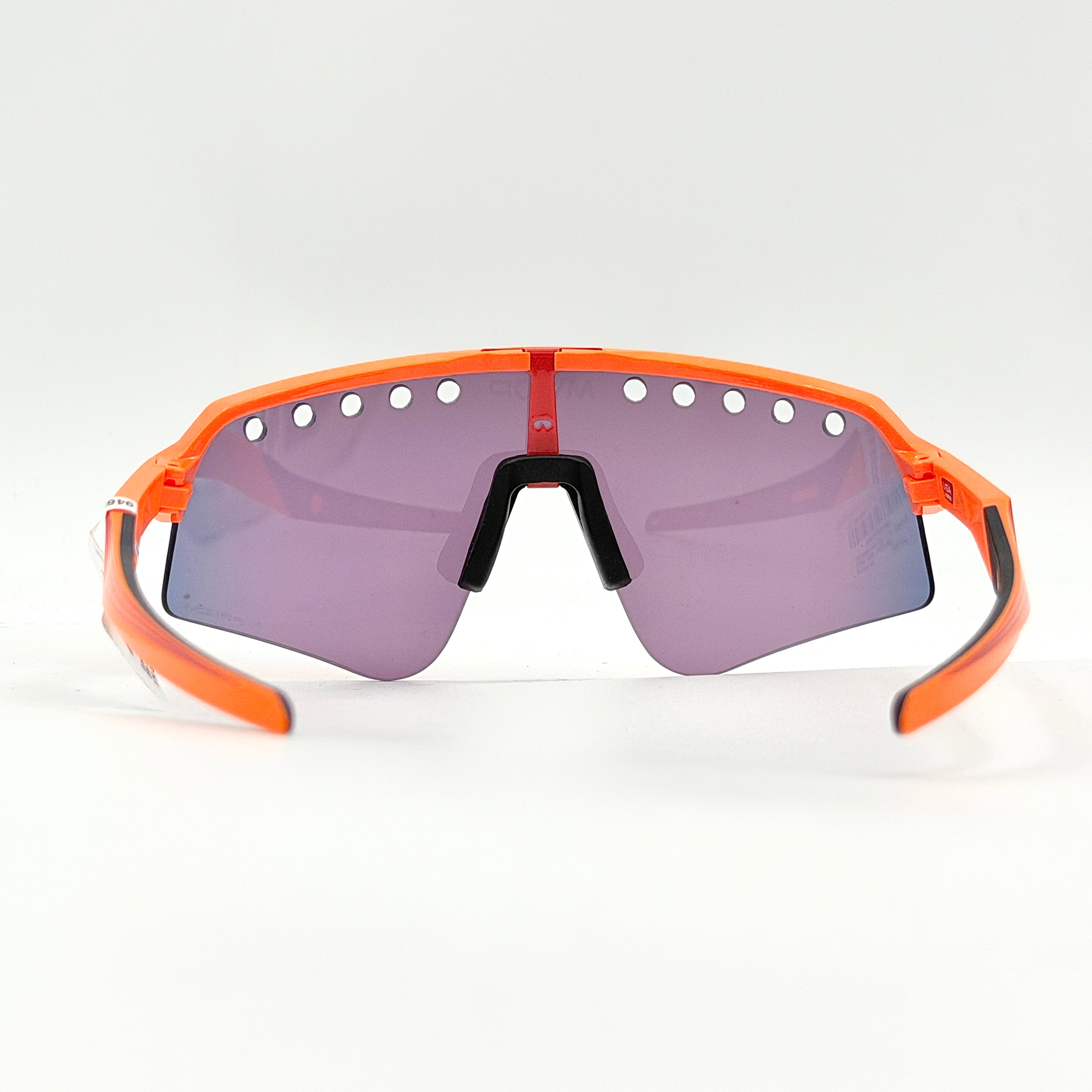 Oakley Sutro Lite Sweep MVDP Prizm Road sunglasses in orange sparkle with a shield lens and original pouch, photographed in bright studio lighting.
