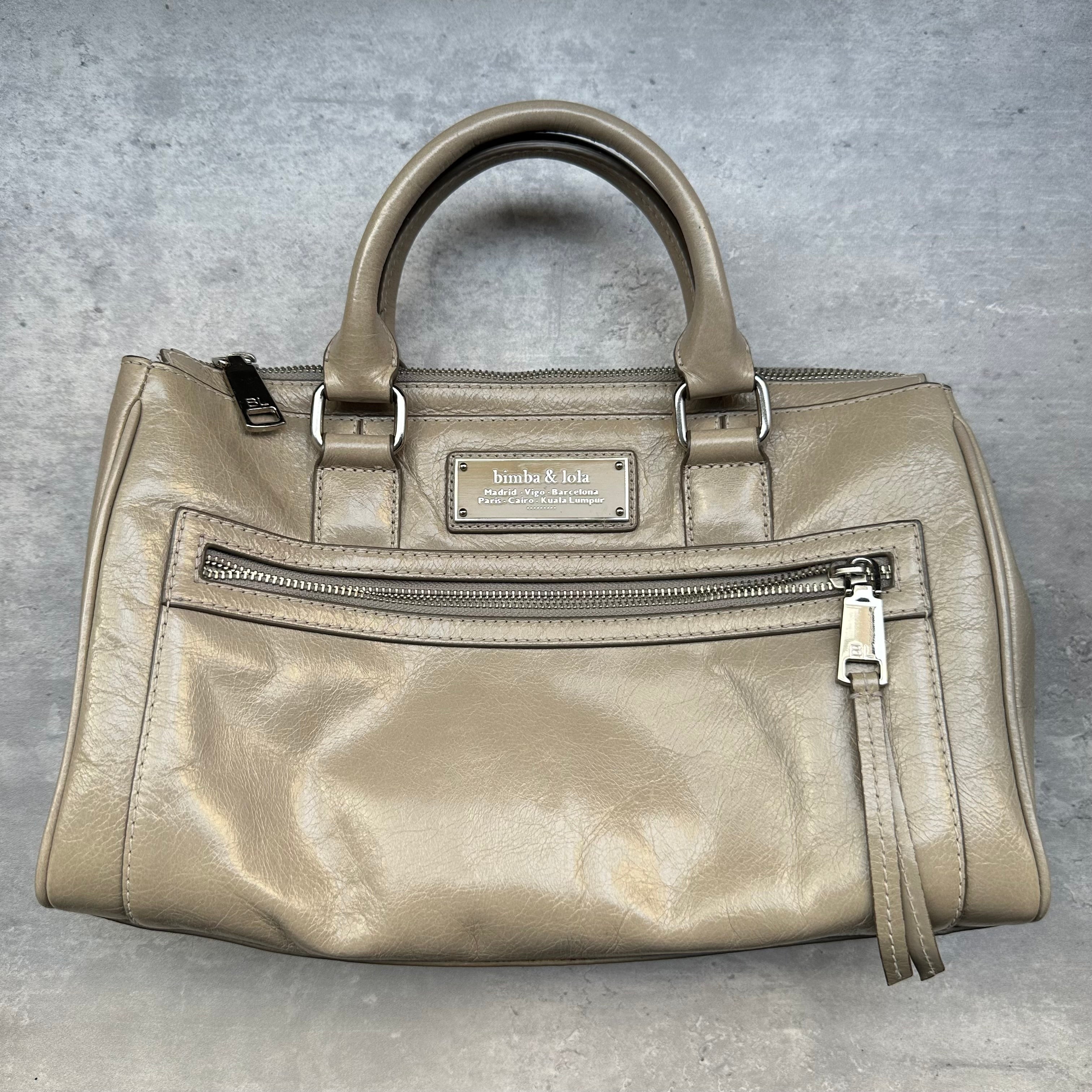 Front view of Bimba & Lola Leather Shoulder Bag with top handles and zipper pocket