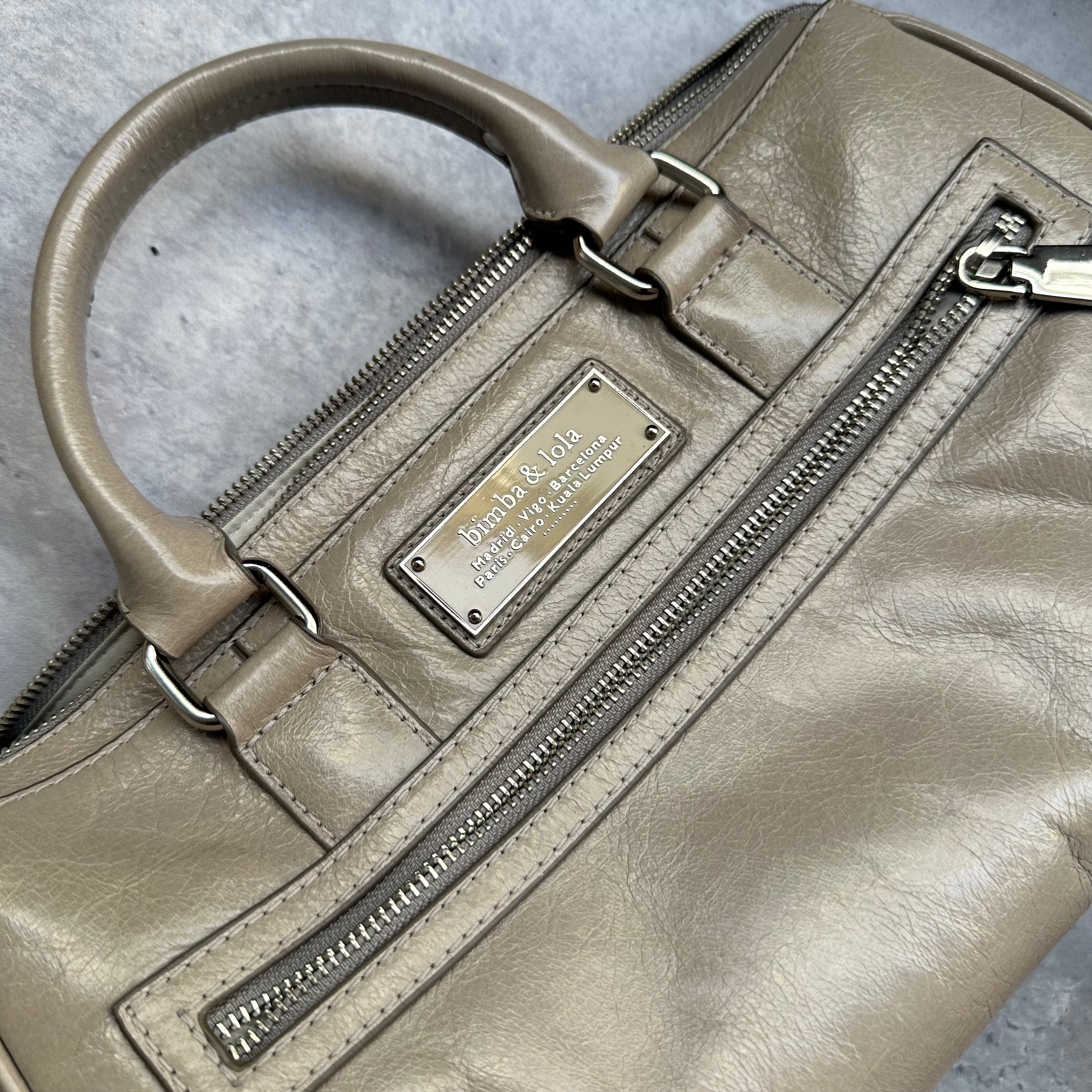 Detail view of Bimba & Lola metal logo plaque and front pocket