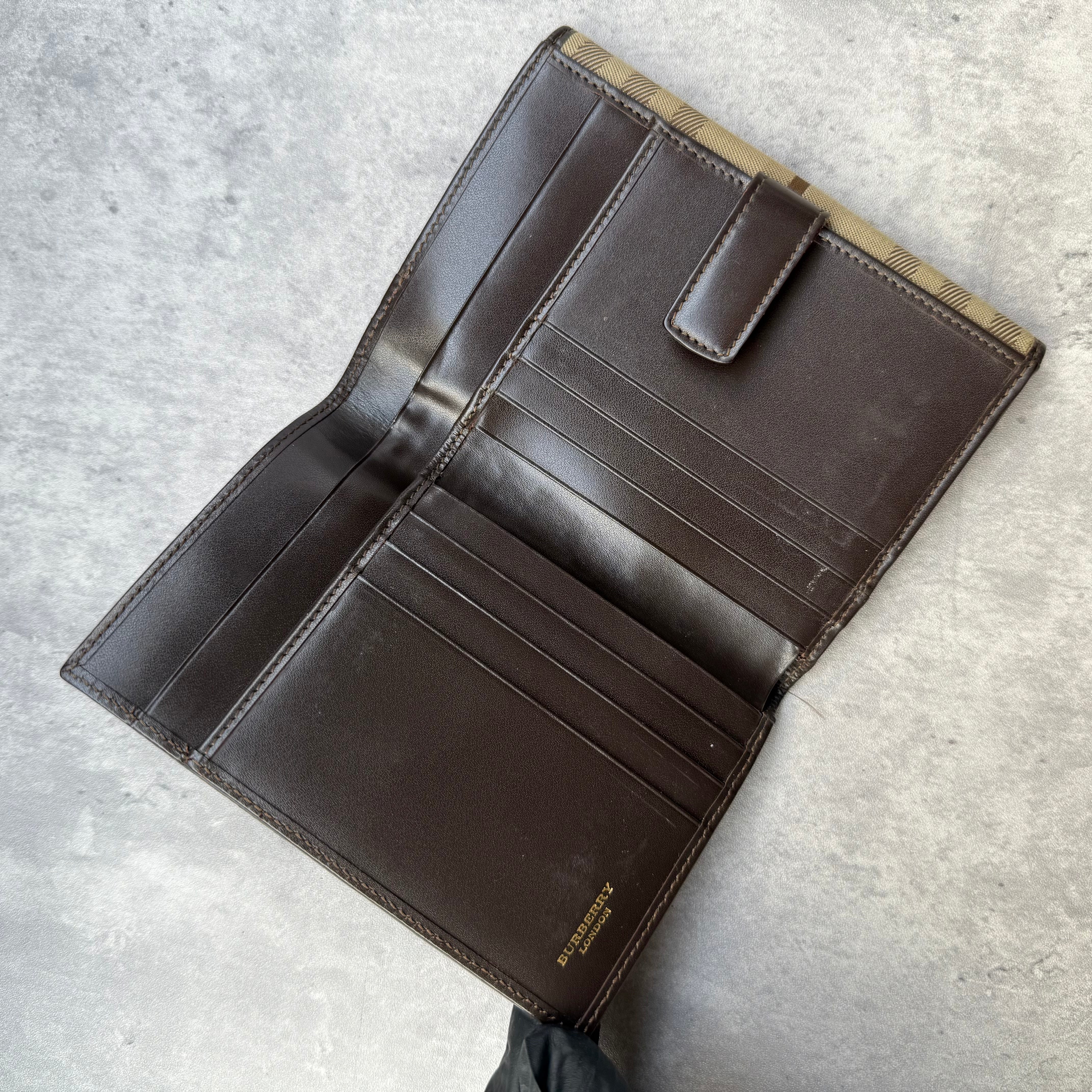 Burberry Nova Check Wallet in beige tartan canvas with brown leather trim, fold-out design, and multiple compartments.