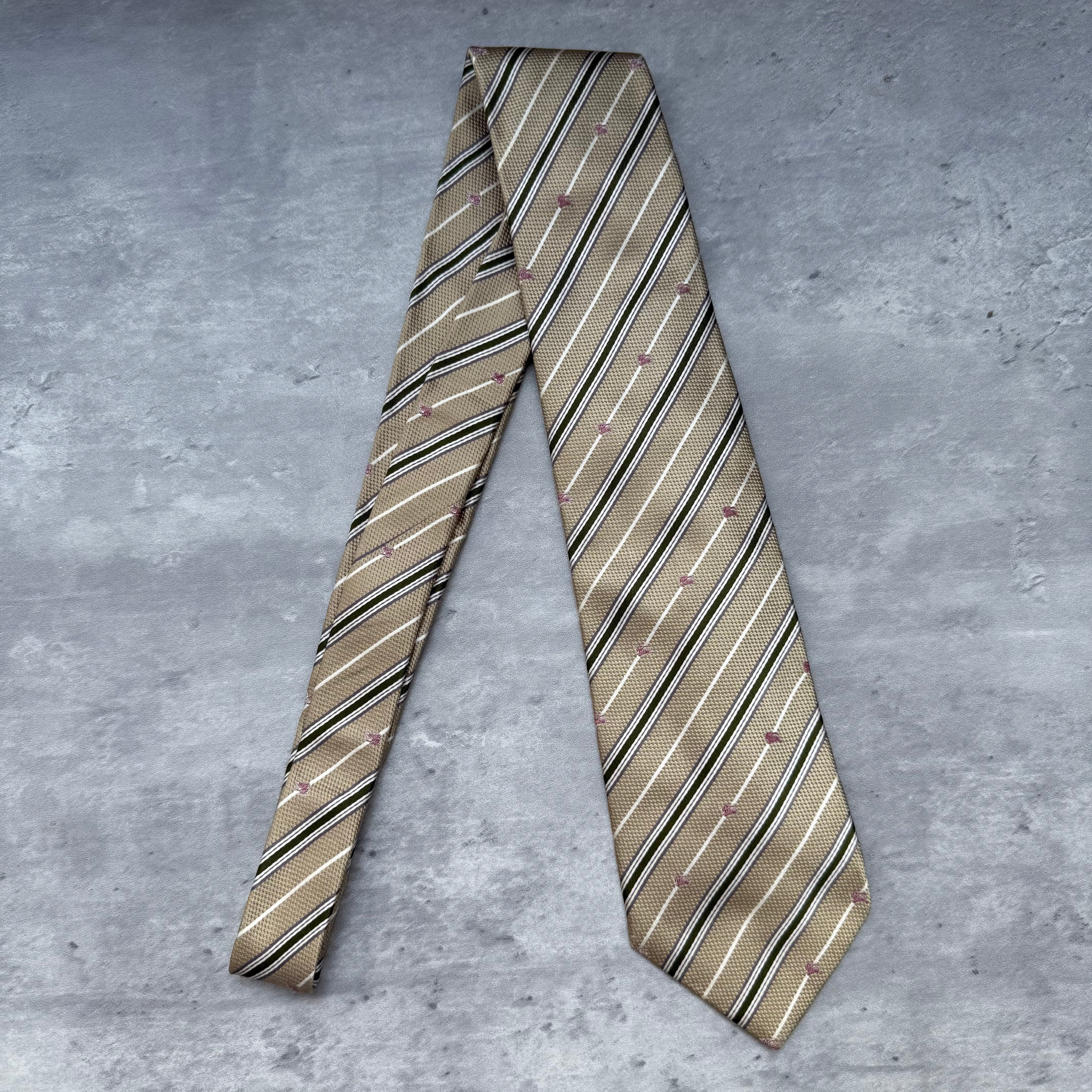 Burberry Striped Silk Neck Tie in beige with black, white, and red diagonal stripes, crafted from silk.