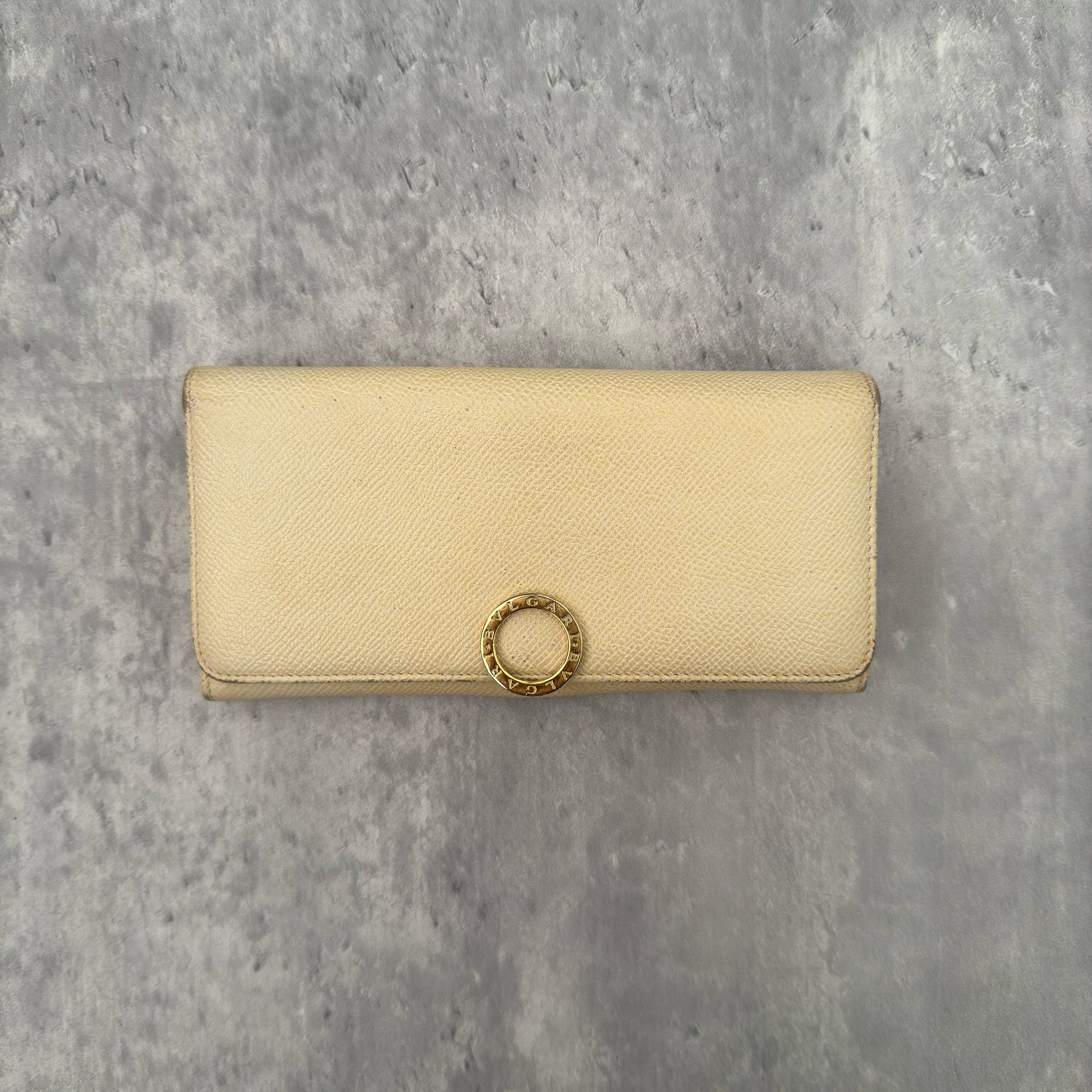 Bvlgari B.Zero1 Beige Saffiano Leather Long Wallet featuring a gold-tone ring clasp and fuchsia pink leather interior.