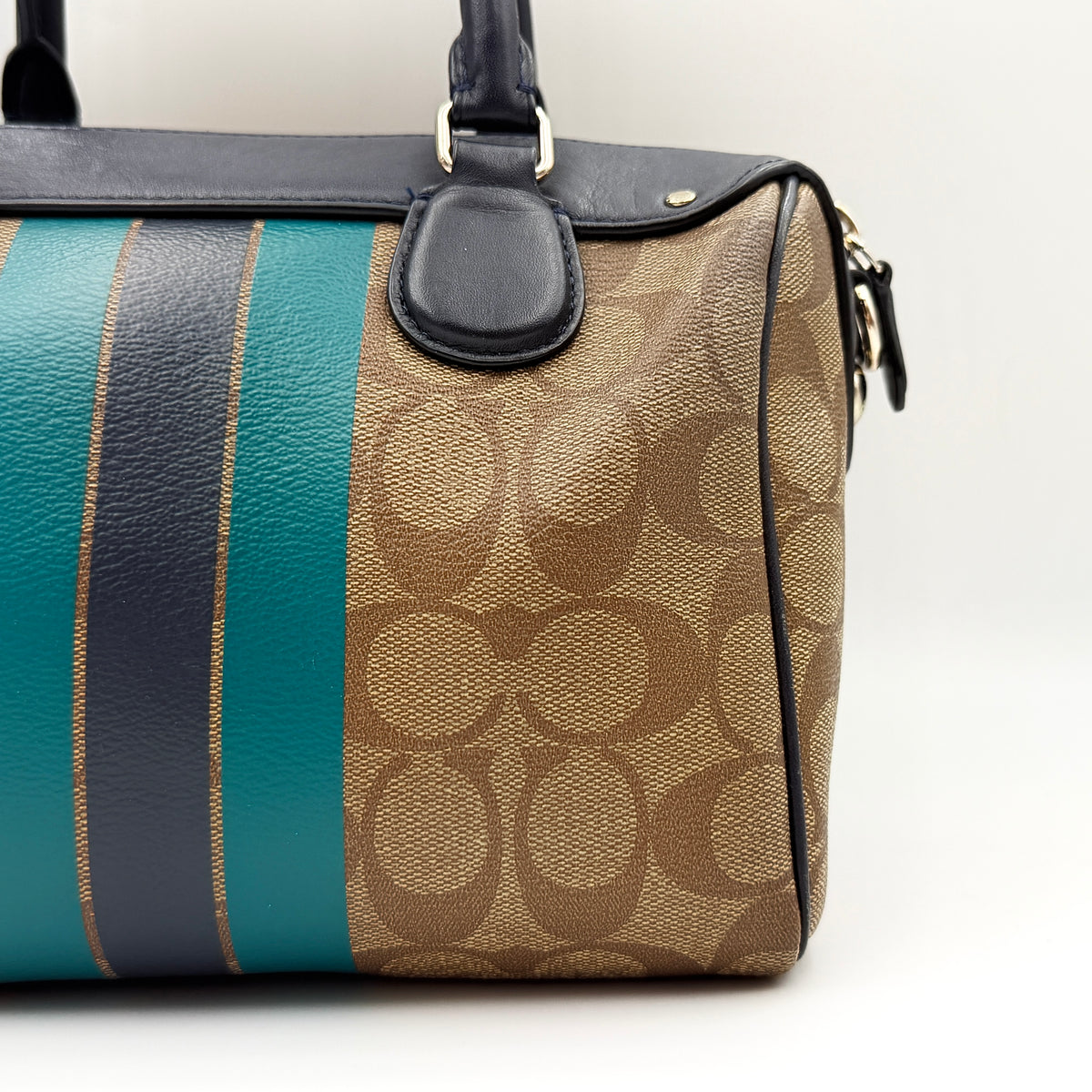 Coach Signature Mini Bennett Boston Bag in monogram canvas with navy and teal varsity stripes and dark navy leather trim.