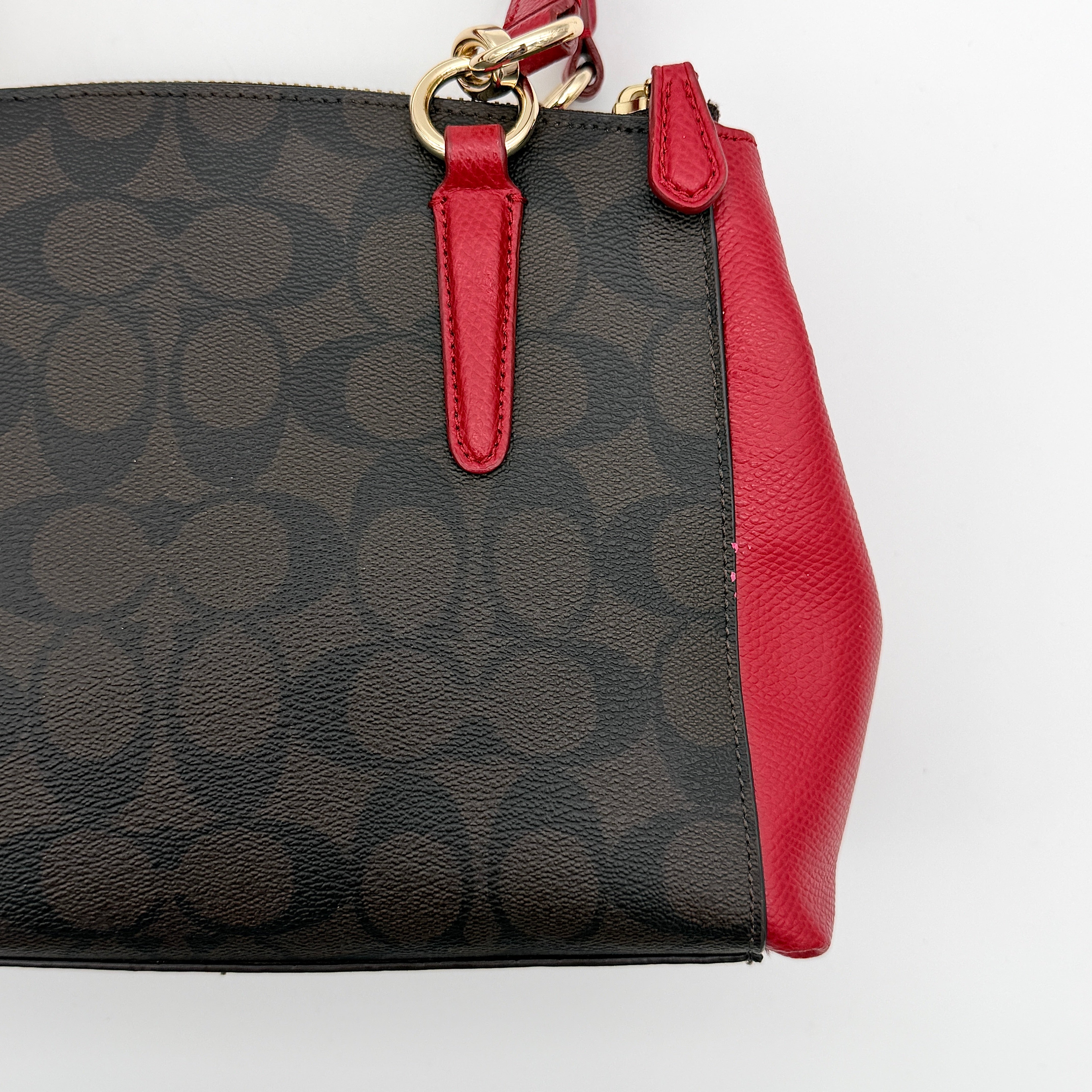 Coach 2Way Christie Carryall in brown coated canvas with red leather handles and sides, gold hardware, shown with detachable strap.